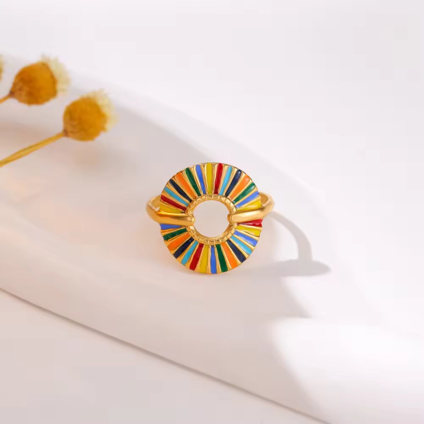 Close-up of the Rainbow Sunburst Adjustable Ring with multicolored enamel segments and 18K gold plating, showcasing intricate details.