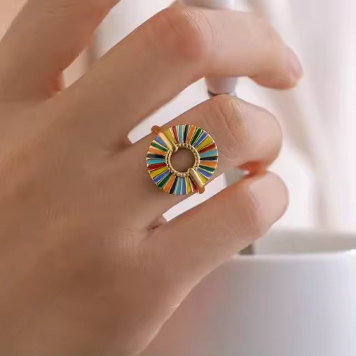 18K Gold Plated Rainbow Sunburst Adjustable Ring with vibrant multicolored enamel inlay, shown on a model's hand to highlight its striking sunburst design.