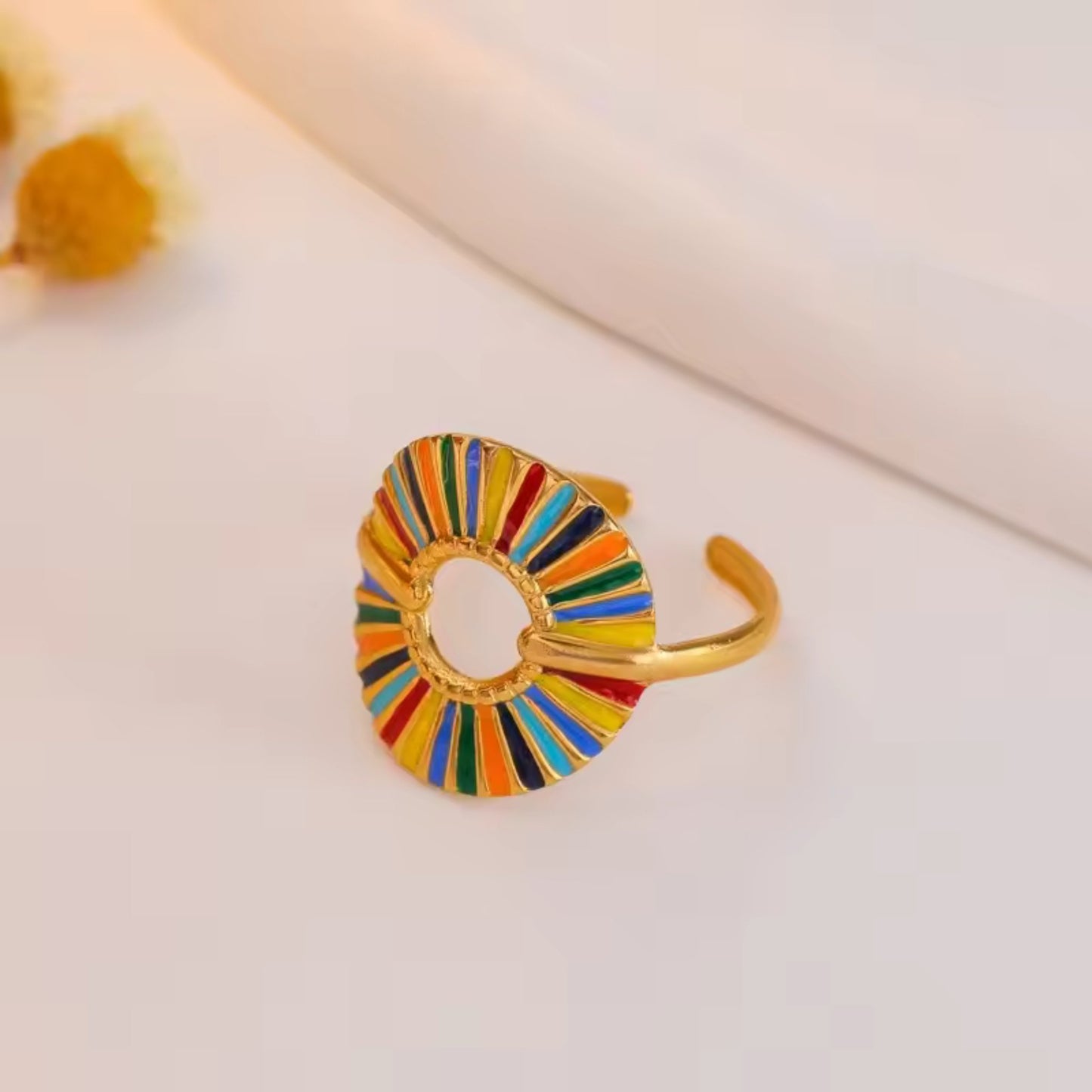 Close-up of the Rainbow Sunburst Adjustable Ring with multicolored enamel segments and 18K gold plating, showcasing intricate details.