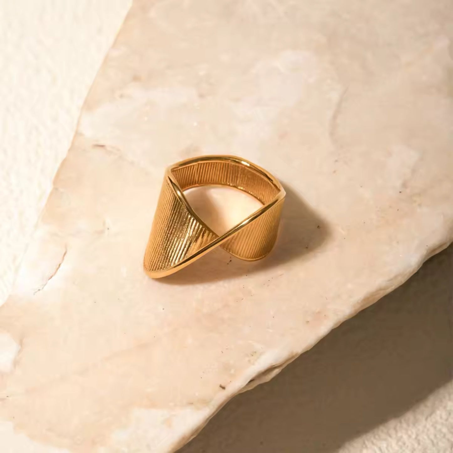 Close-up photo for the 18K Gold Plated Wave Texture Ring paired for a sophisticated and glamorous ensemble.