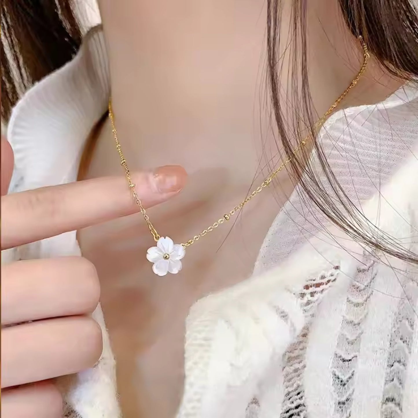 Blossom Beauty Flower Necklace featuring a mother of pearl flower pendant and 18K gold-plated beaded chain, styled on a model for an elegant look.