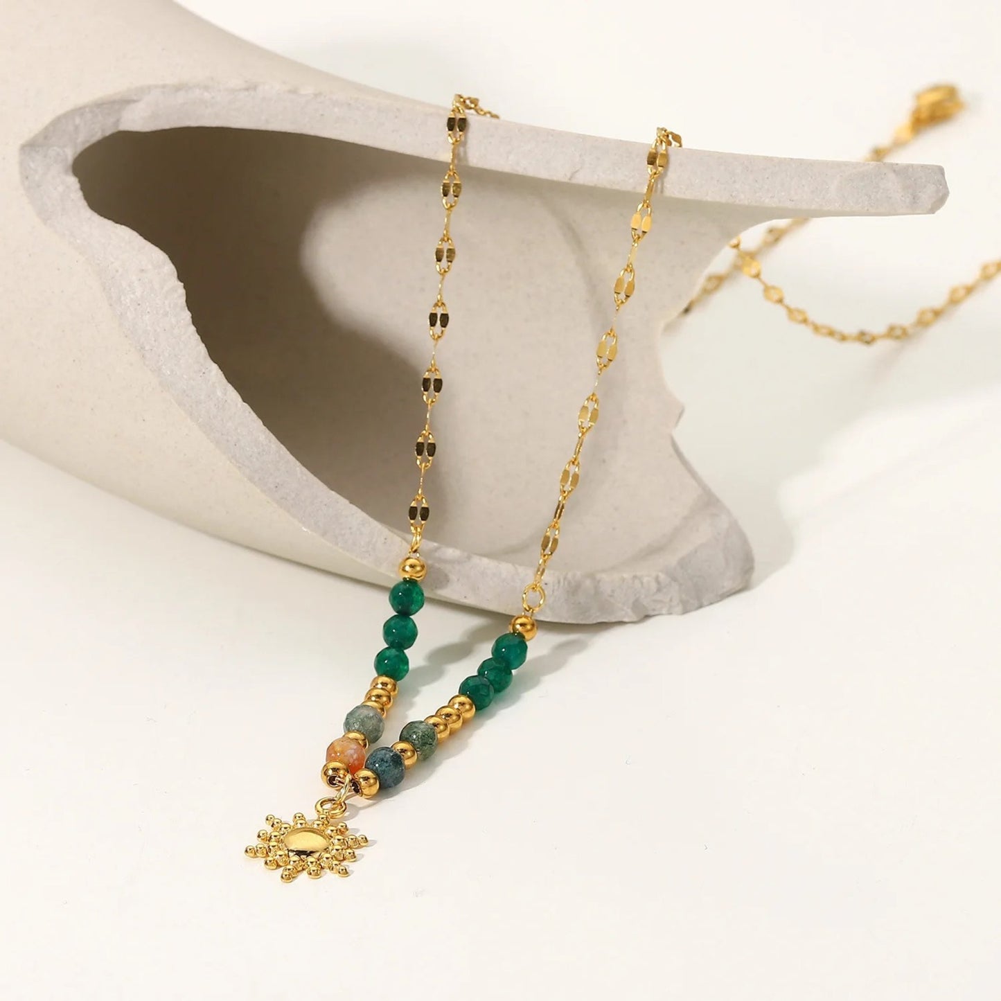 Boho Sun Pendant Necklace with semi-precious stones and a gold-plated sun pendant, presented in nice scene, perfect for special occasions.