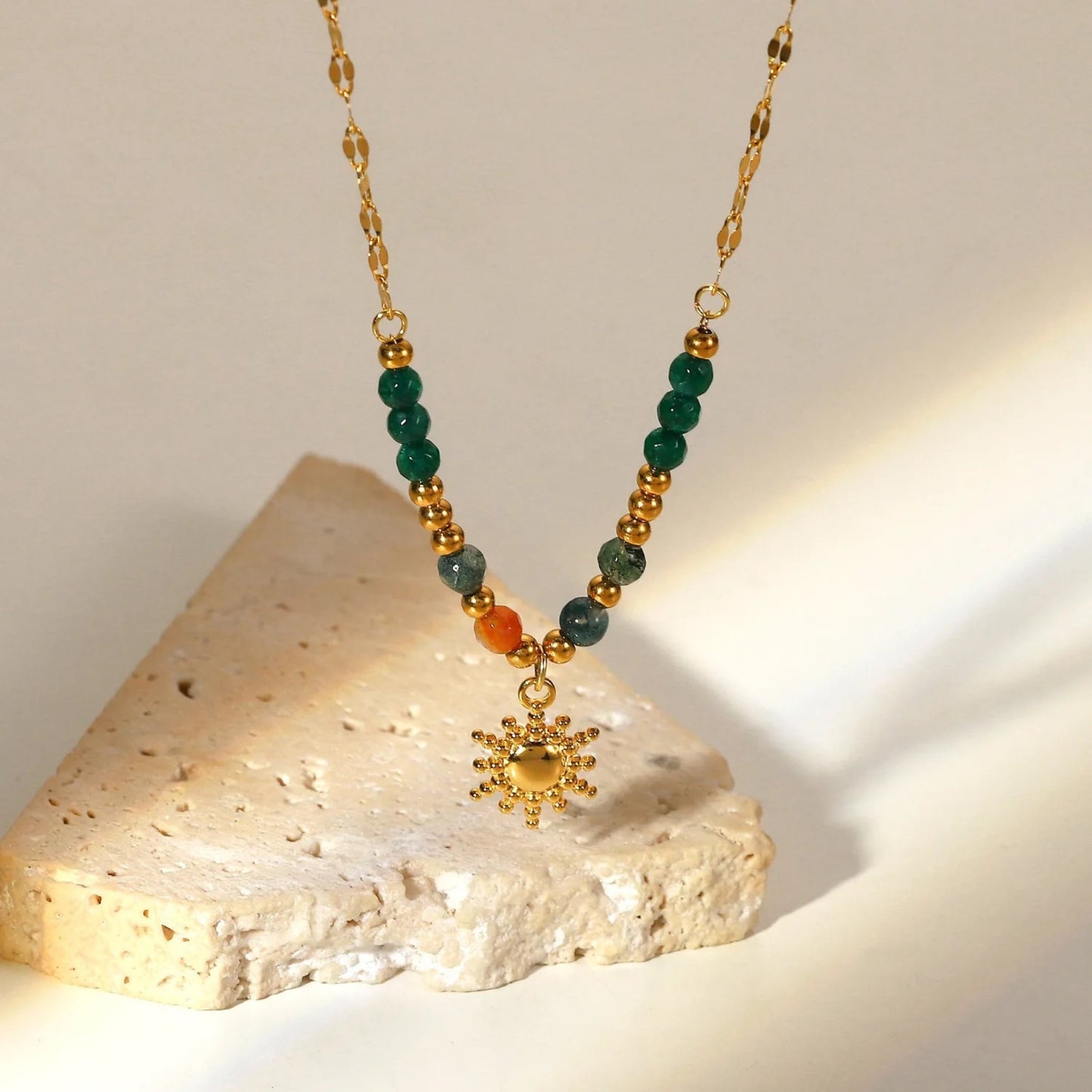 Close-up of the Boho Sun Pendant Necklace showcasing its vibrant semi-precious stones and gold-plated sun pendant.