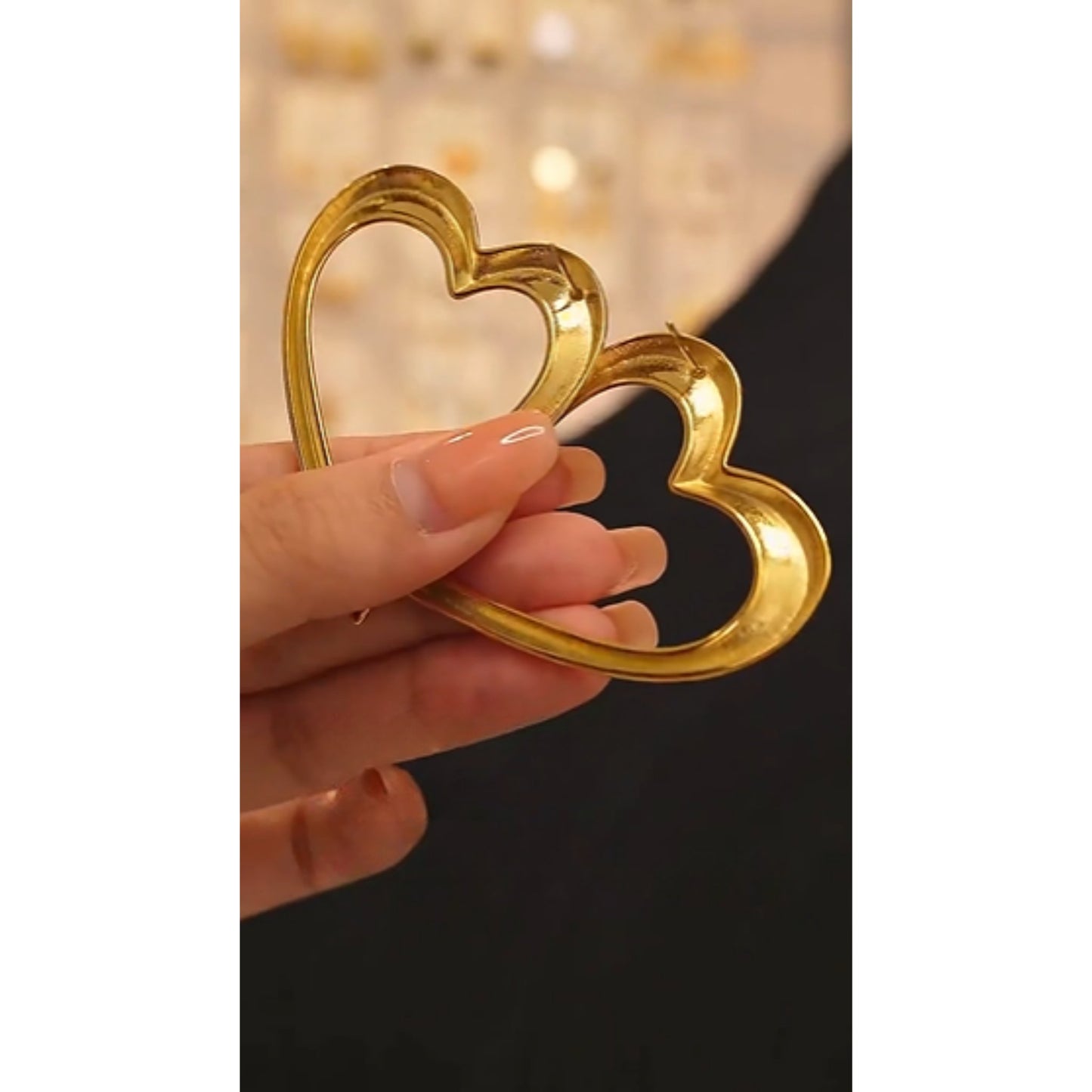Close-up of the Bold Open-Heart Statement Earrings in 18K gold-plated stainless steel, showcasing their minimalistic heart shape.