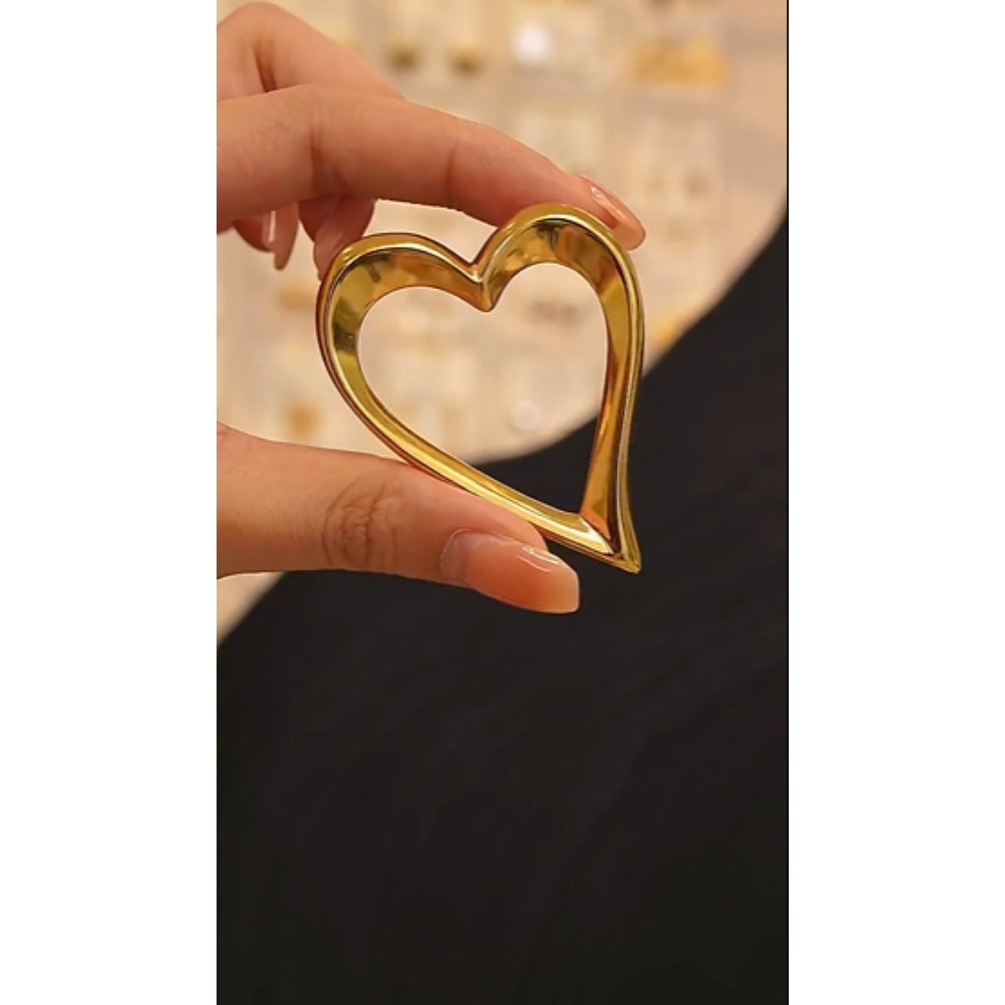 Bold Open-Heart Statement Earrings in gold, styled on a model to highlight their modern and sleek heart-shaped design.