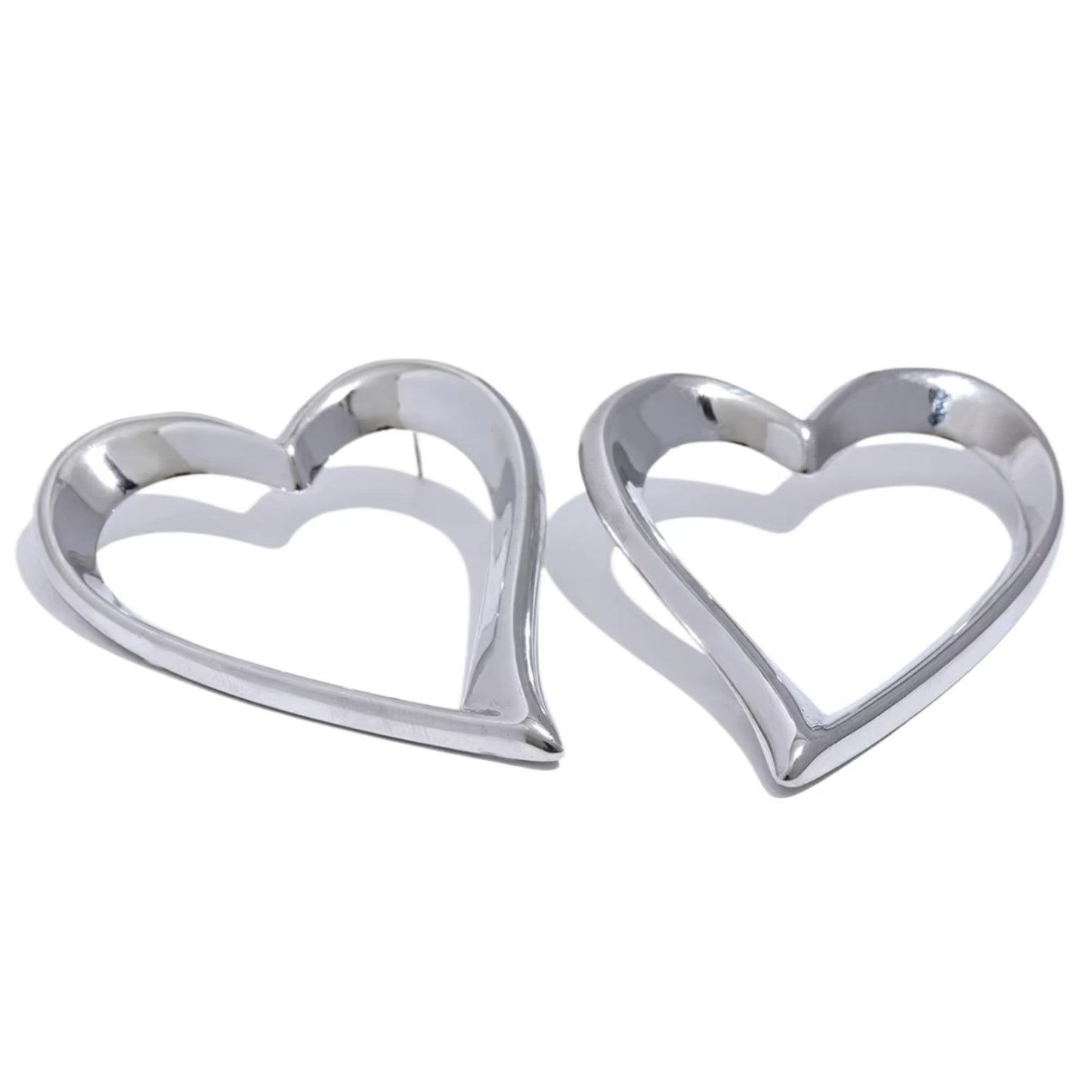 Bold Open-Heart Statement Earrings in silver-tone stainless steel with a minimalistic heart-shaped design for elegant style.