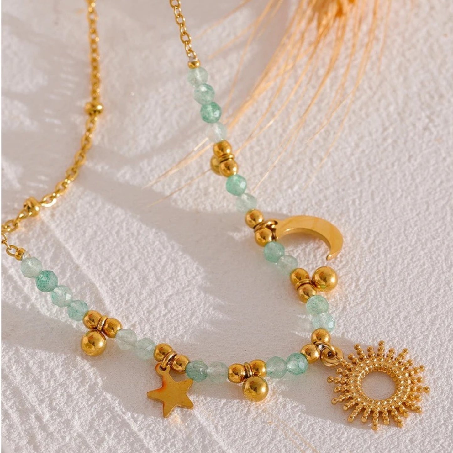 Close-up of the Celestial Harmony Charm Necklace showcasing celestial charms and delicate faceted bead accents.