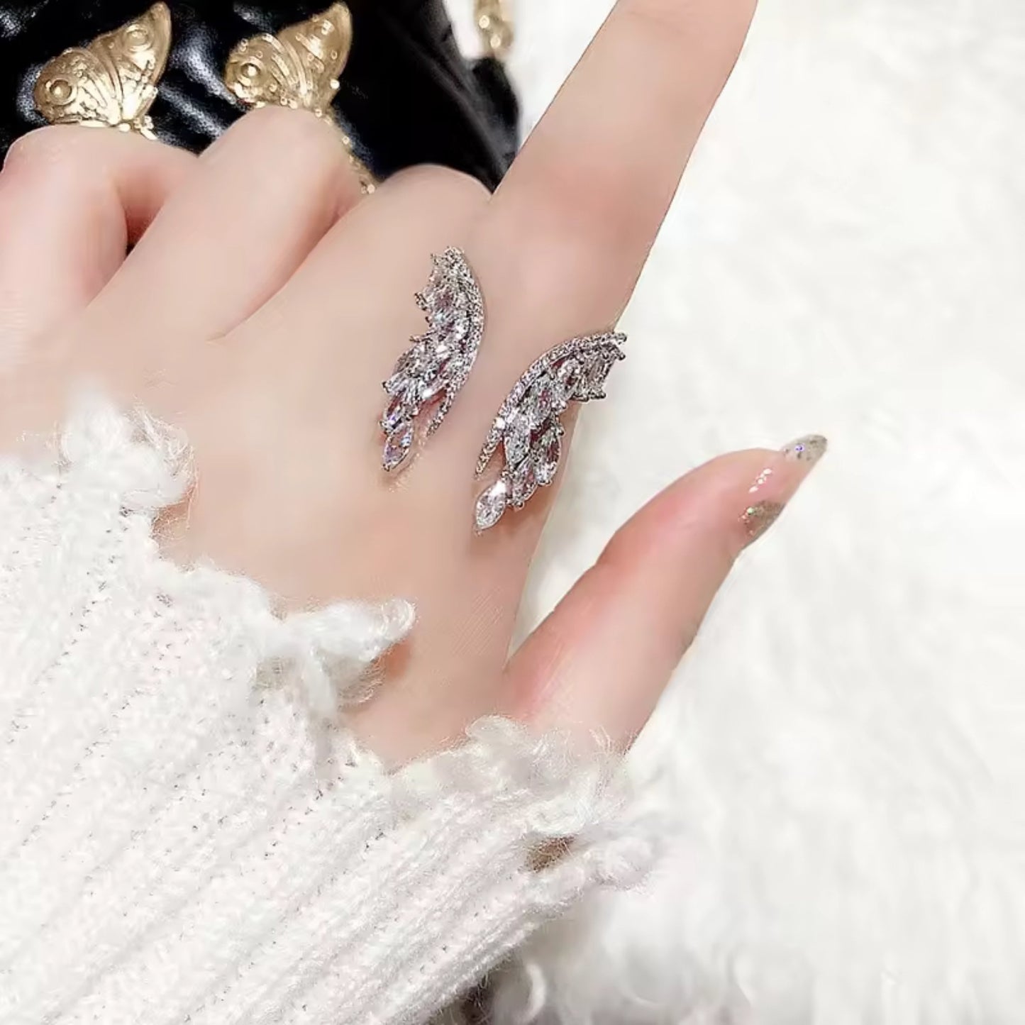 Celestial Wings Adjustable Zircon Ring styled on a hand, showcasing its elegant design and adjustable fit.