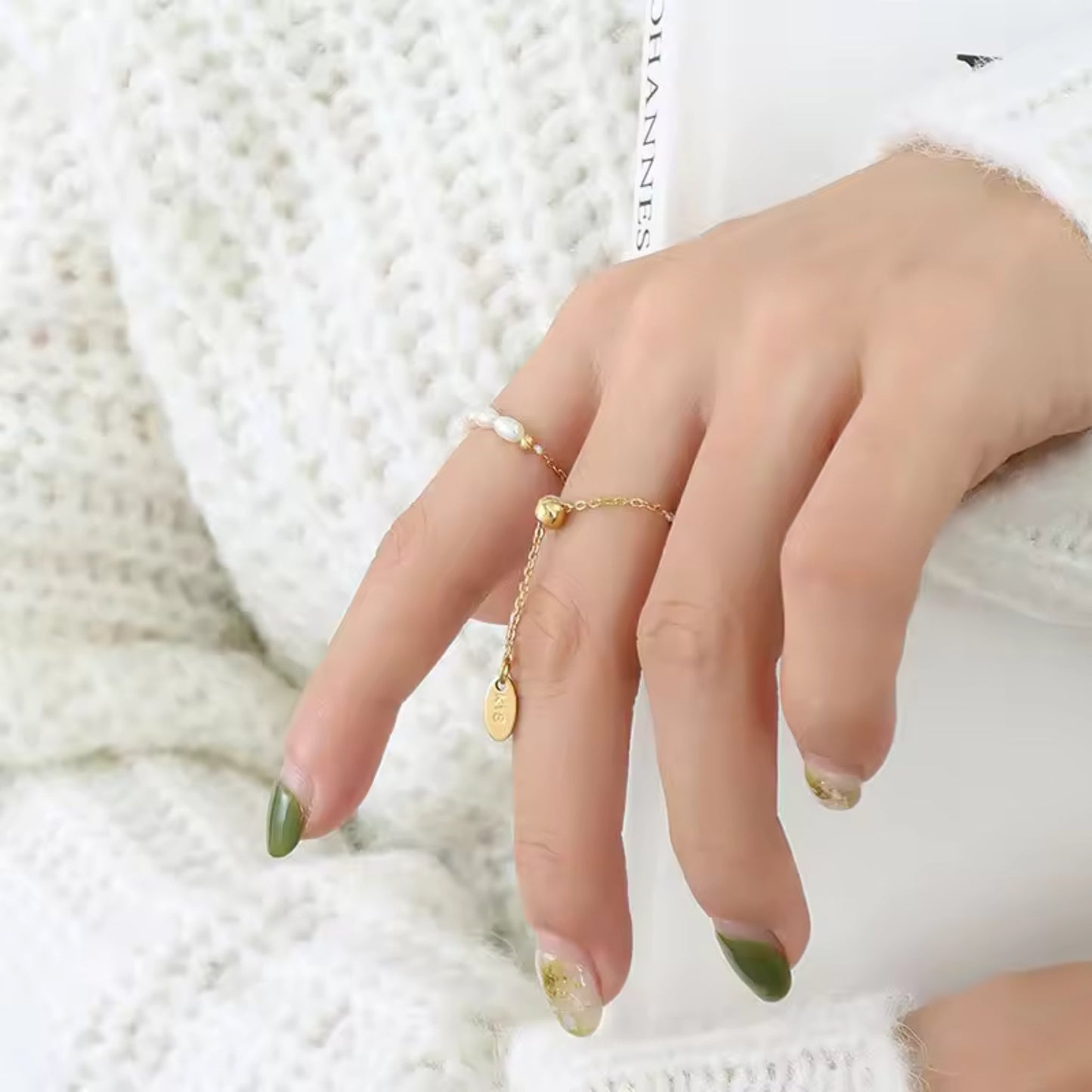 Close up of the CharmLink Adjustable Duo Ring Set styled on fingers, featuring the pearl-accented and chain-link rings for a modern, elegant look.