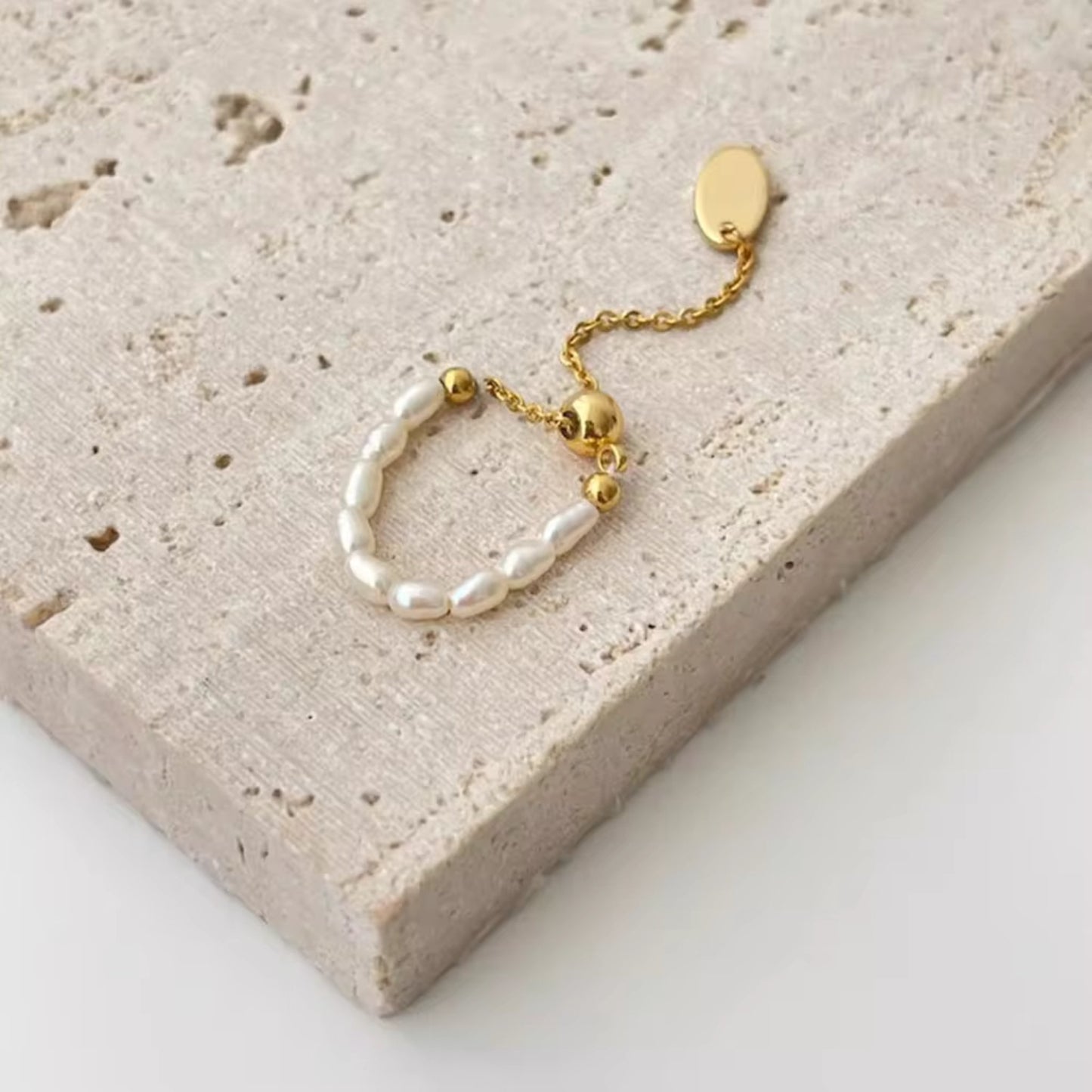 Close-up of the pearl-accented ring from the CharmLink Adjustable Duo Ring Set, showcasing its classic and refined design.