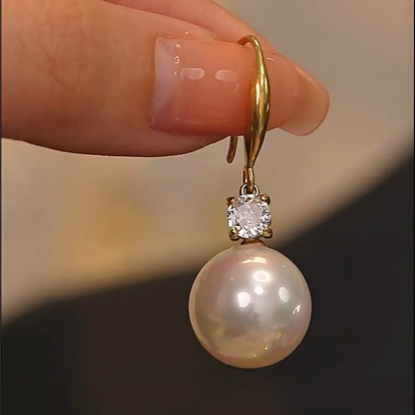 Close-up of the Classic Pearl Drop Earrings highlighting the radiant pearl and zirconia stone set in a detailed gold-plated frame.