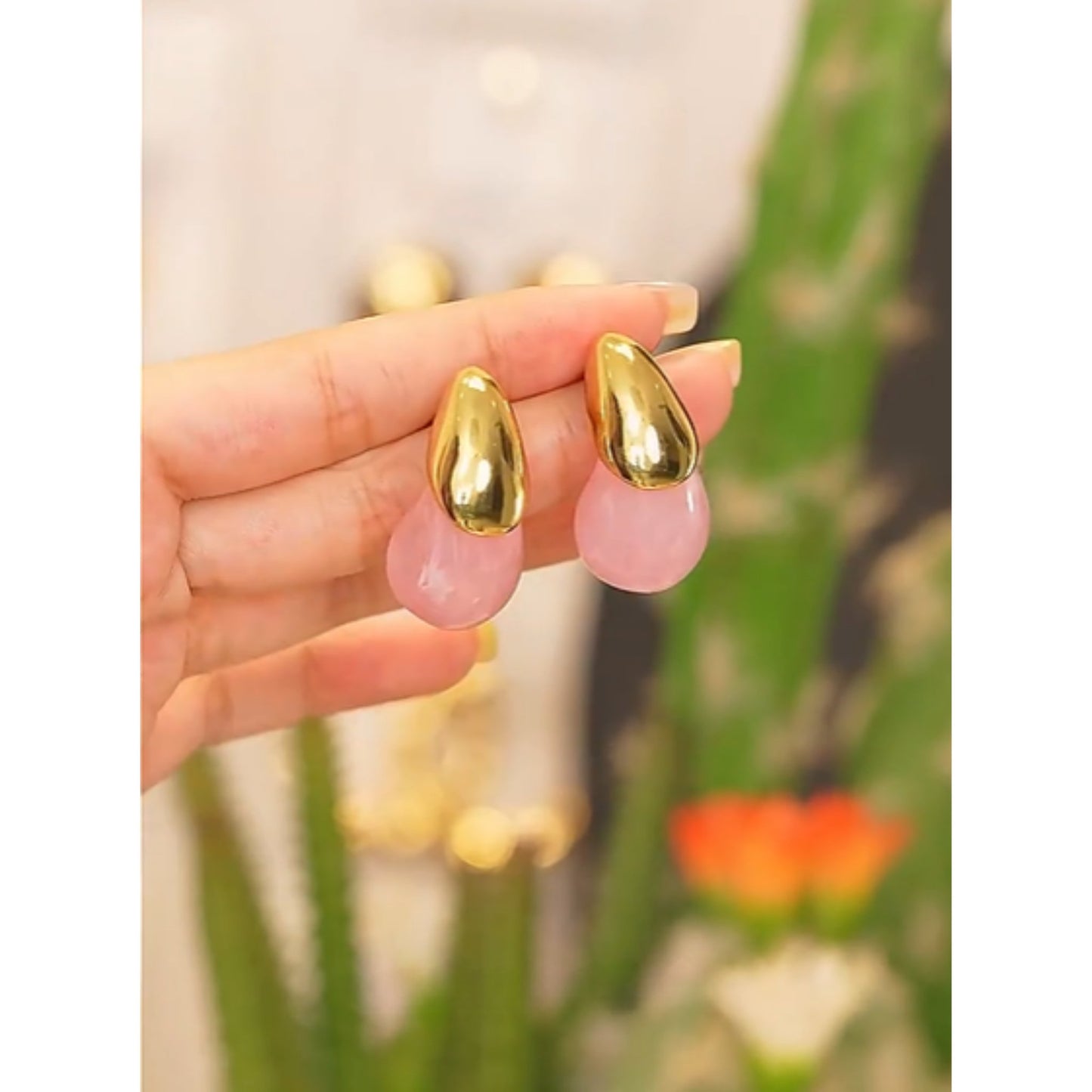 Close-up of the Color Splash Gold-Tipped Drop Earrings showcasing the fluid design and luxurious gold-plated top.