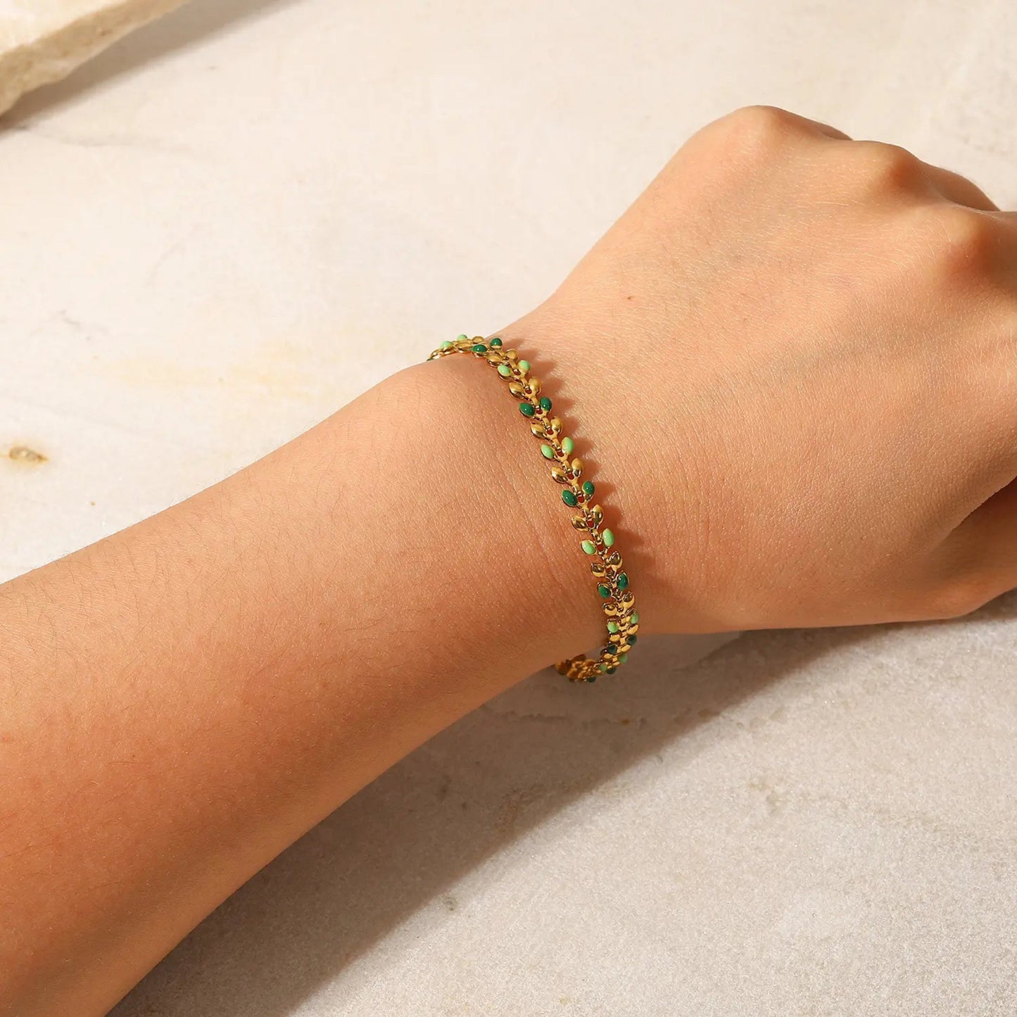 Colorful Leaf Drop Bracelet worn on a wrist, highlighting its playful leaf design and colorful accents.