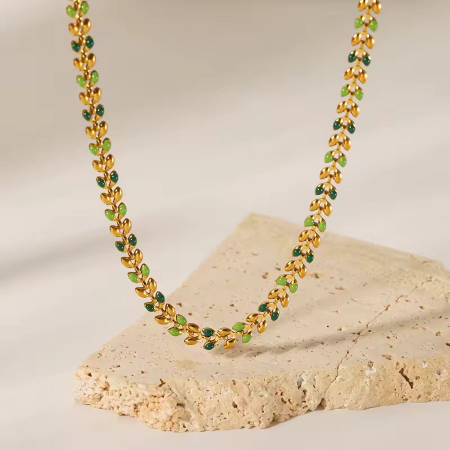 Close-up of the delicate leaf-shaped links with colorful oil drop accents on the Colorful Leaf Drop Necklace.