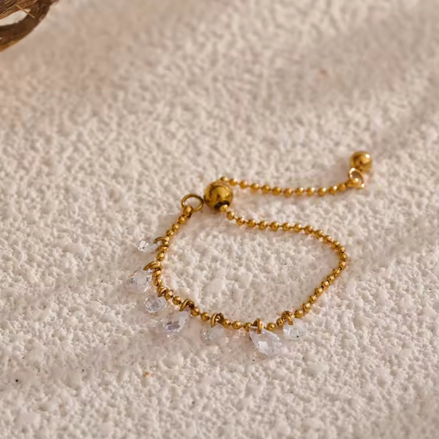 Close-up of the adjustable slider on the Crystal Charm Beaded Ring for a custom fit.