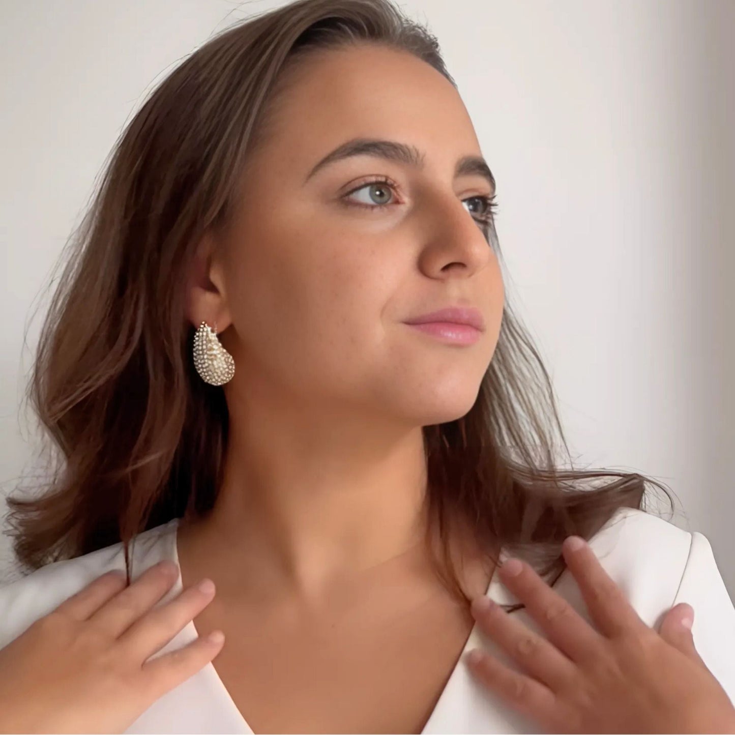 Model wearing the Crystal Embellished Gold Teardrop Earrings with faceted crystals set in 18K PVD gold plating.