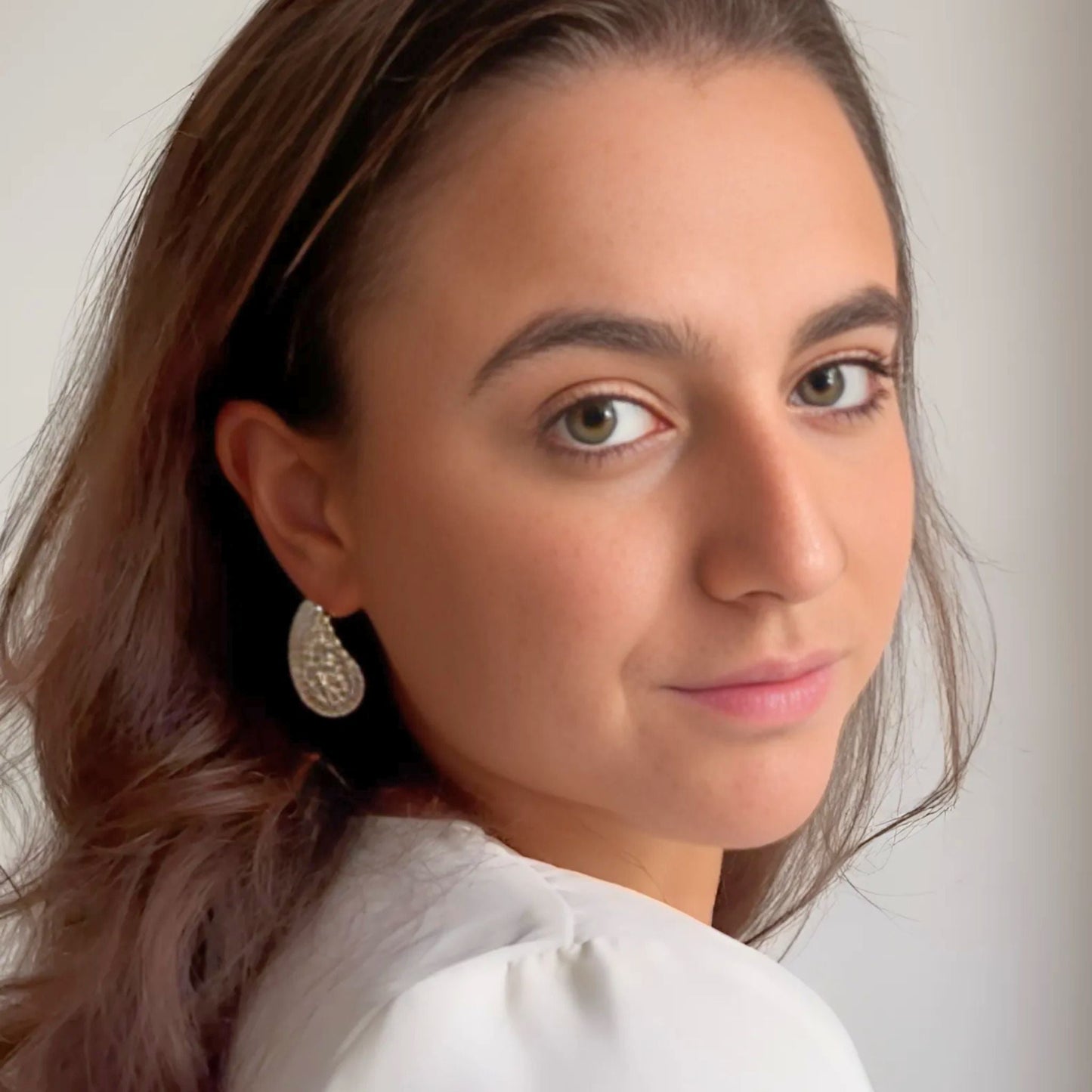 Model wearing the Crystal Embellished Gold Teardrop Earrings with faceted crystals set in 18K PVD gold plating.