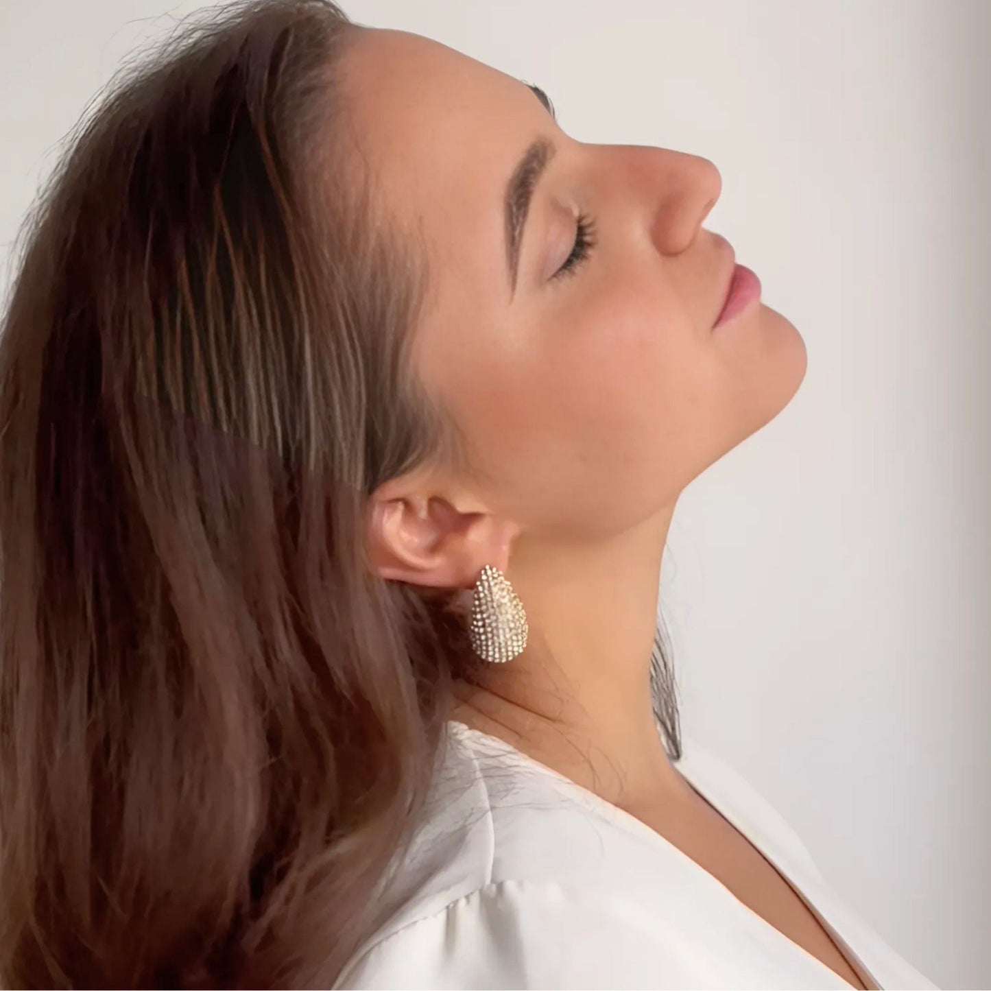 Model wearing the Crystal Embellished Gold Teardrop Earrings with faceted crystals set in 18K PVD gold plating.