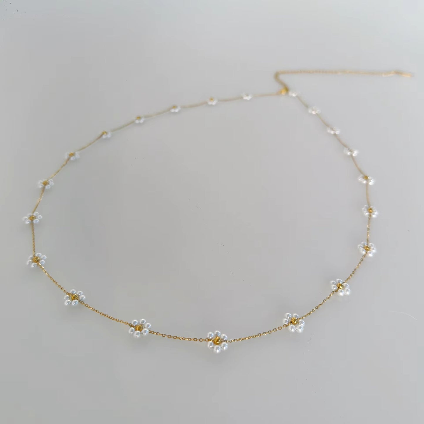 Daisy Dreams Belly Chain with pearl daisy accents and an 18K gold-plated finish.