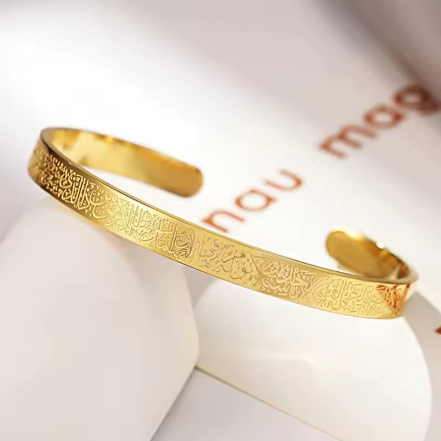Close-up of the engraved Al Kursi Verse on the 18K gold-plated open cuff bangle.