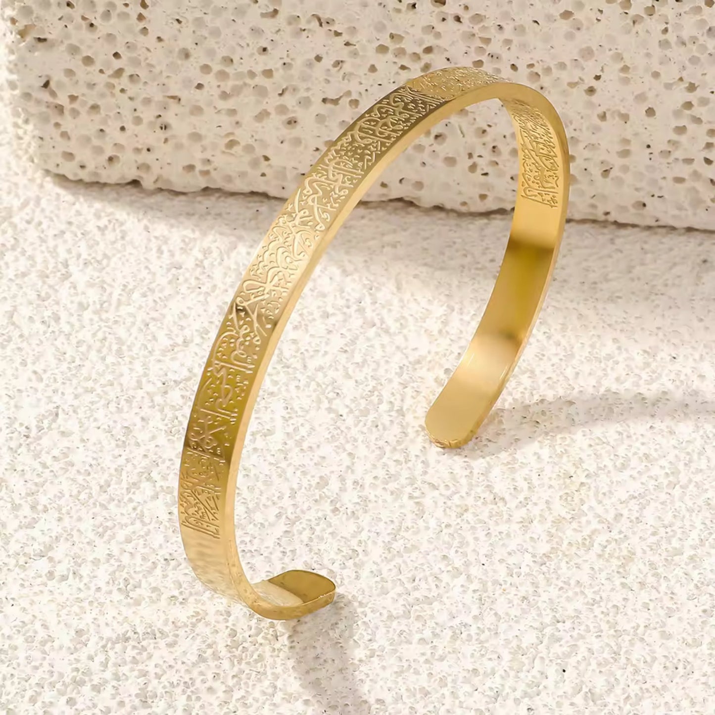 Close-up of the engraved Al Kursi Verse on the 18K gold-plated open cuff bangle.