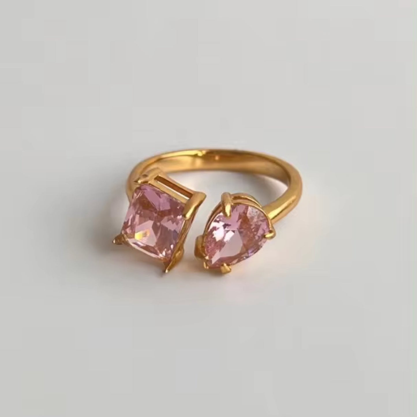 Close-up of the Dual Delight Zircon Ring showcasing the pink zircon combination on a polished 18K gold-plated band.