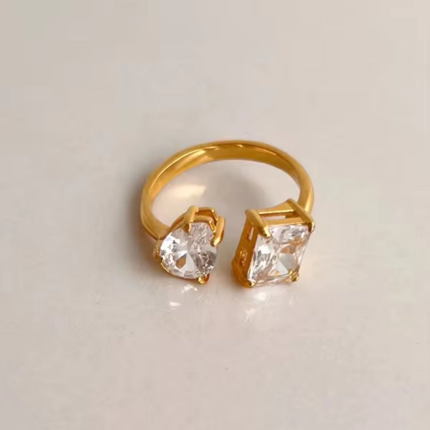 Close-up of the Dual Delight Zircon Ring showcasing the clear zircon combination on a polished 18K gold-plated band.
