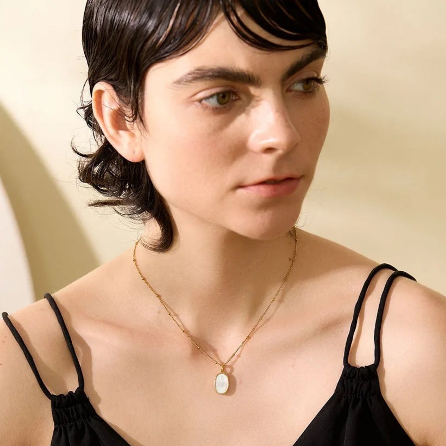 Model wearing the Dual-Sided Shell Pendant Necklace, highlighting its modern elegance and versatile 40cm length.