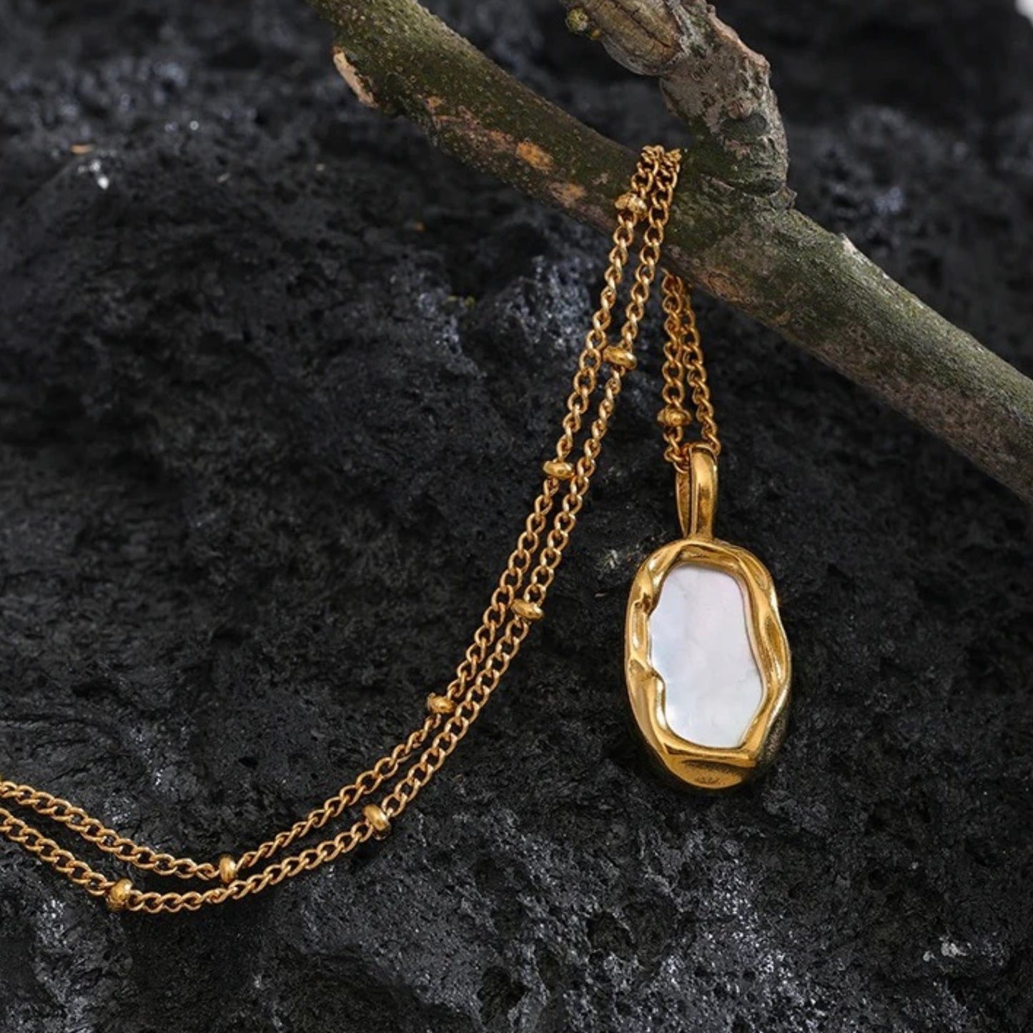 Flat-lay of the Dual-Sided Shell Pendant Necklace with 18mm x 20mm shell pendant and adjustable chain.