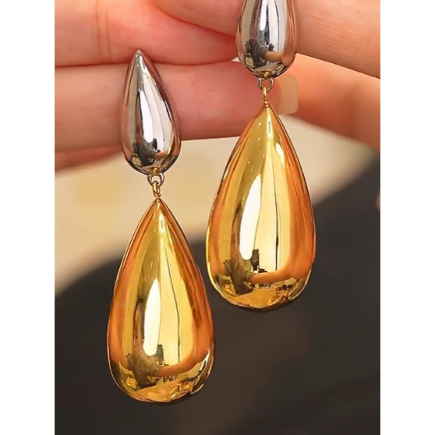 Close-up of Dual-Tone Drop Earrings showcasing the polished finish and striking contrast of silver and gold tones.