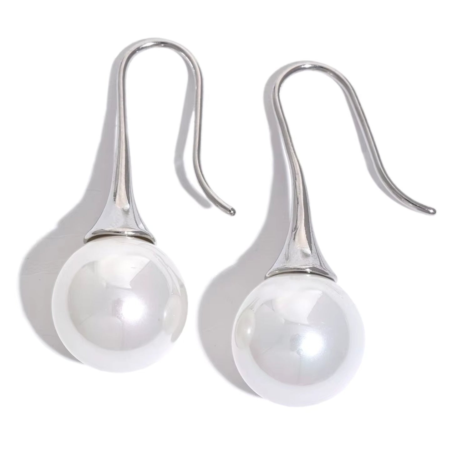 Silver-tone Elegance Pearl Drop Earrings showcasing their lightweight and modern design.