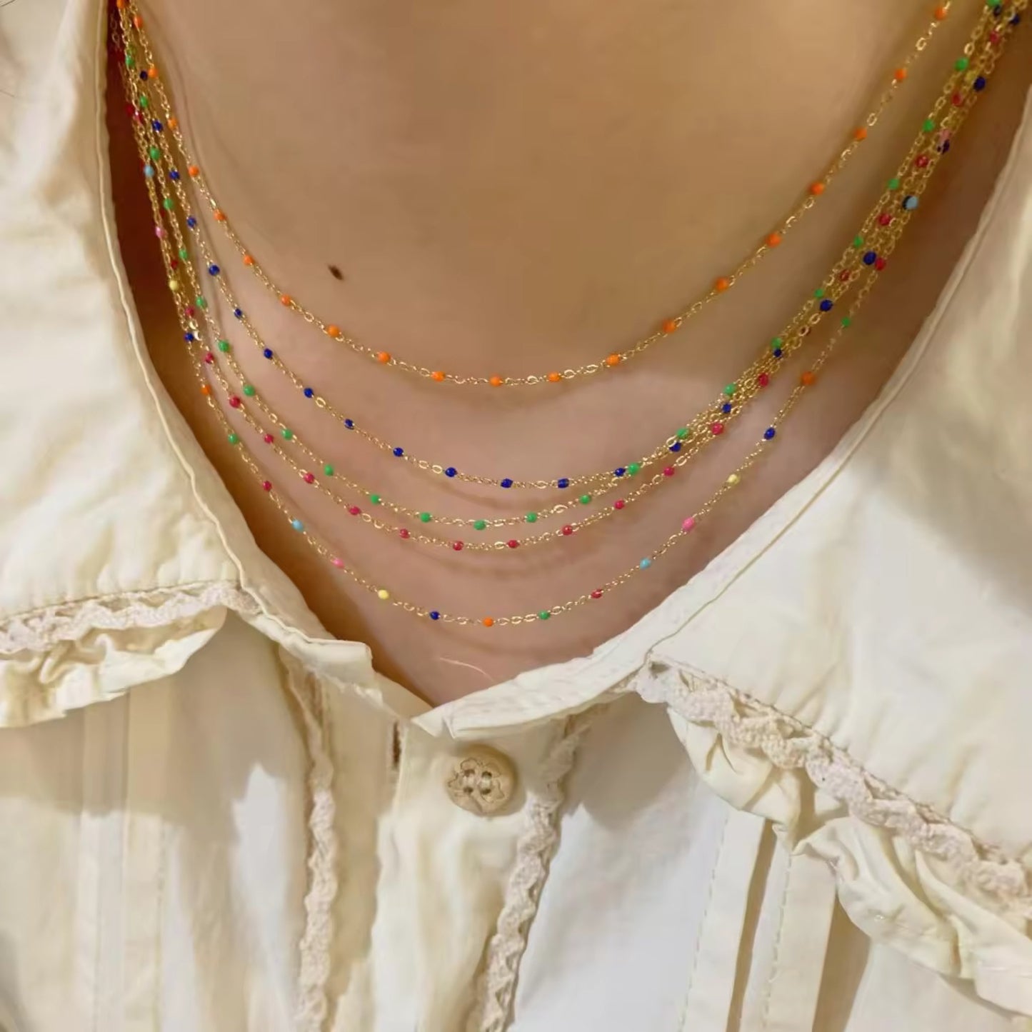Model wearing all four bead options for the Elegant Cascade Necklace Collection: Black, Green, Sky Blue, and Colorful.