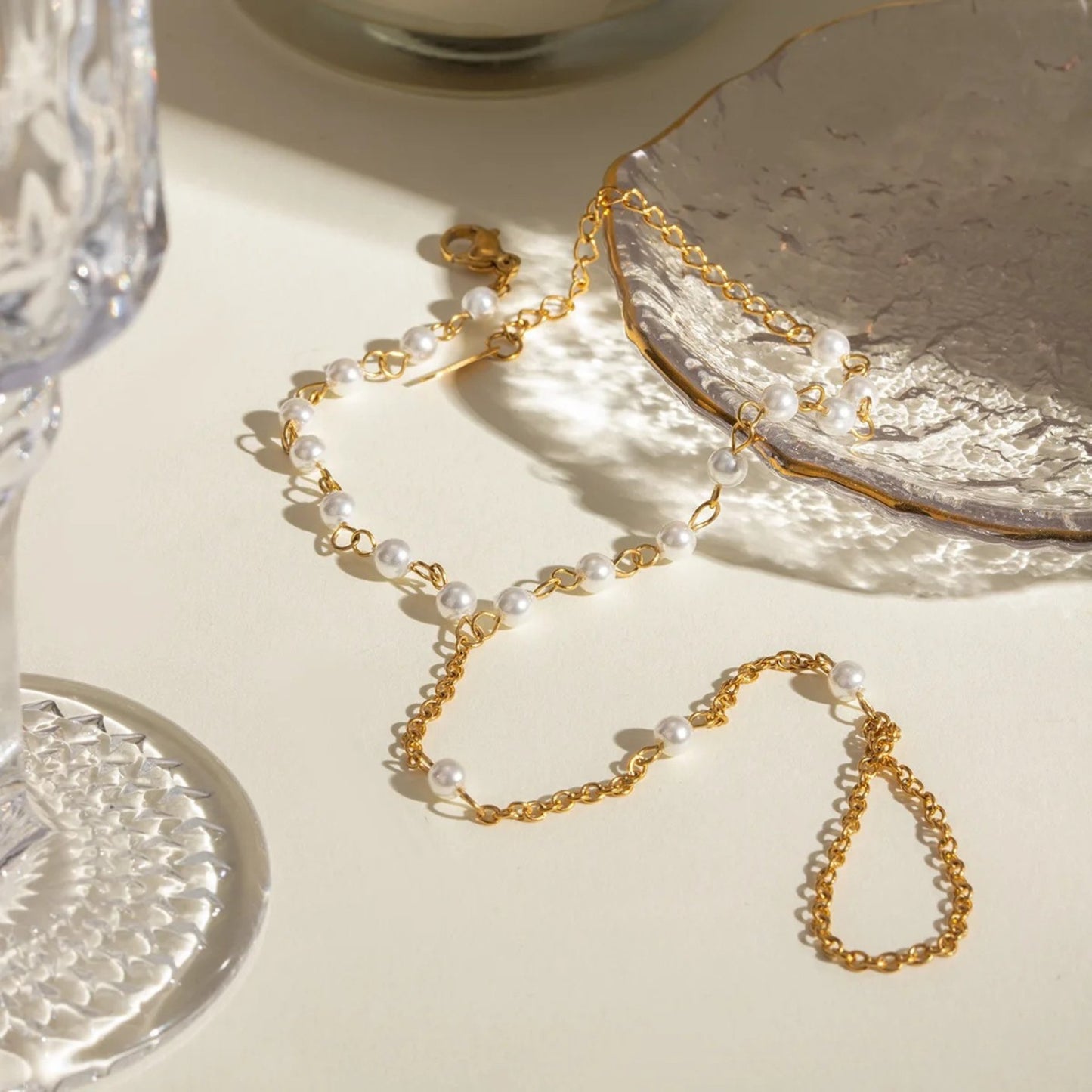 18K gold-plated Chain-Linked Finger Bracelet with pearl accents displayed on a neutral background.