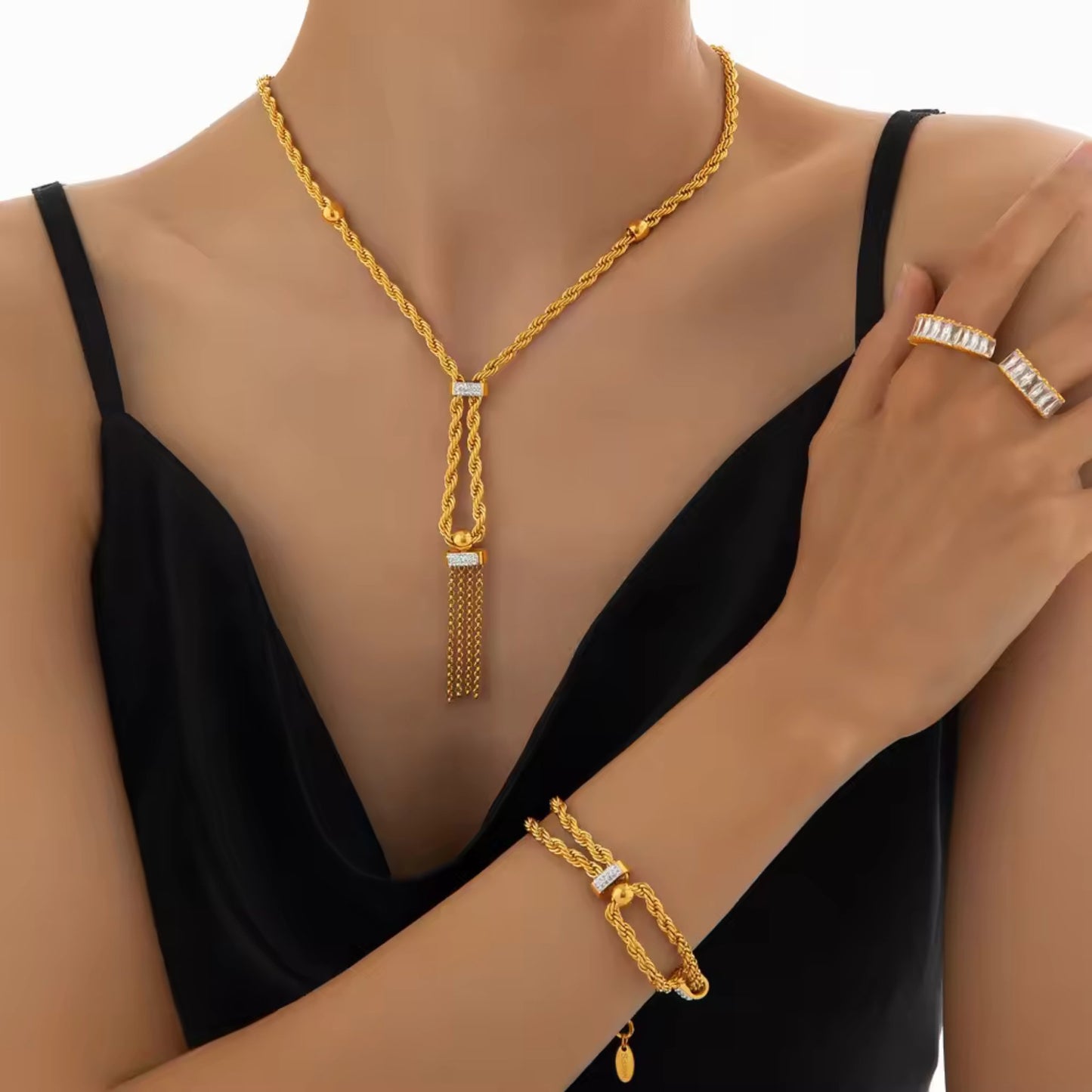 Model wearing the gold-plated necklace and bracelet set, styled with a formal outfit, highlighting its elegant tassel and rhinestone details.