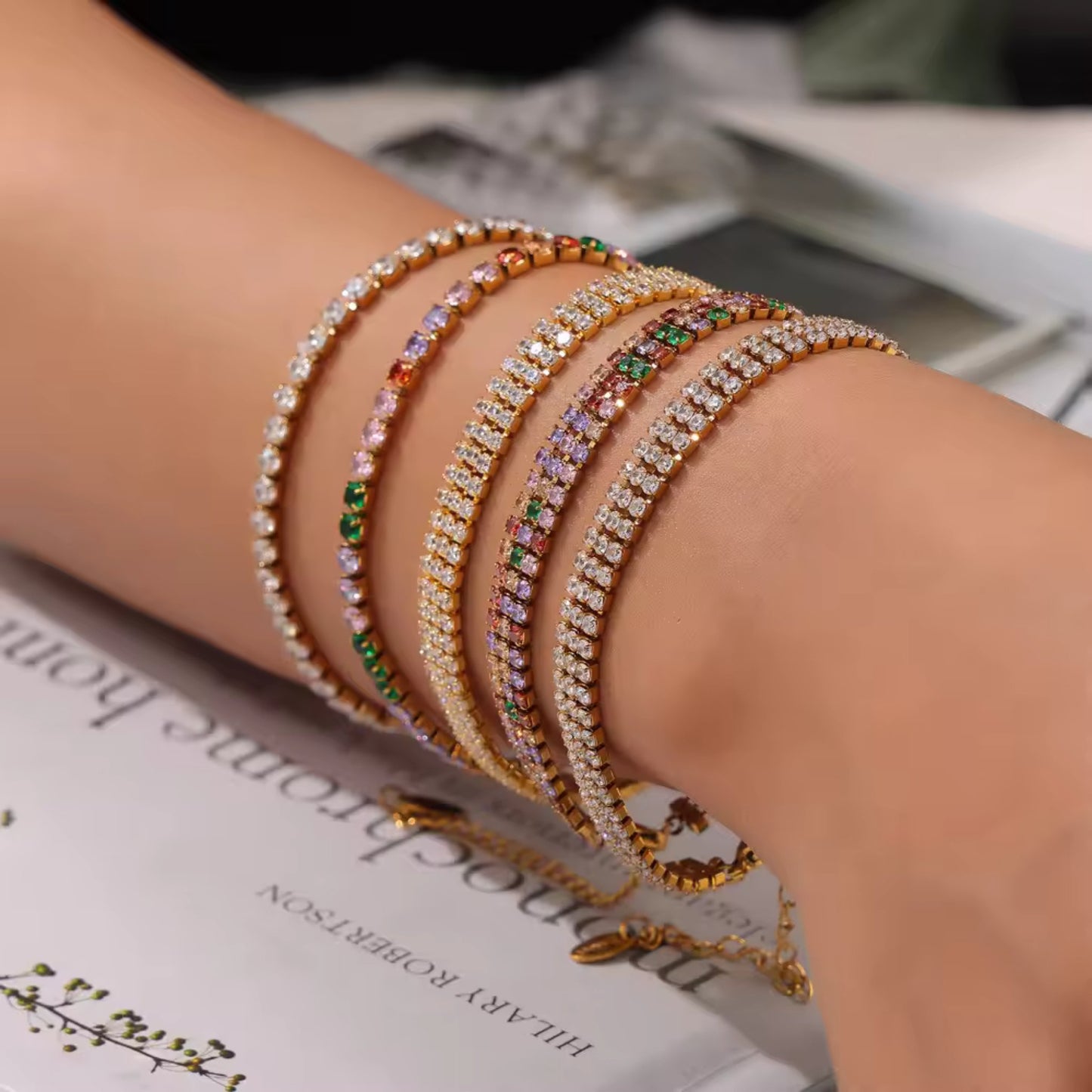 Model wearing a gold-plated zirconia tennis bracelet, highlighting its sparkle and adjustable fit.