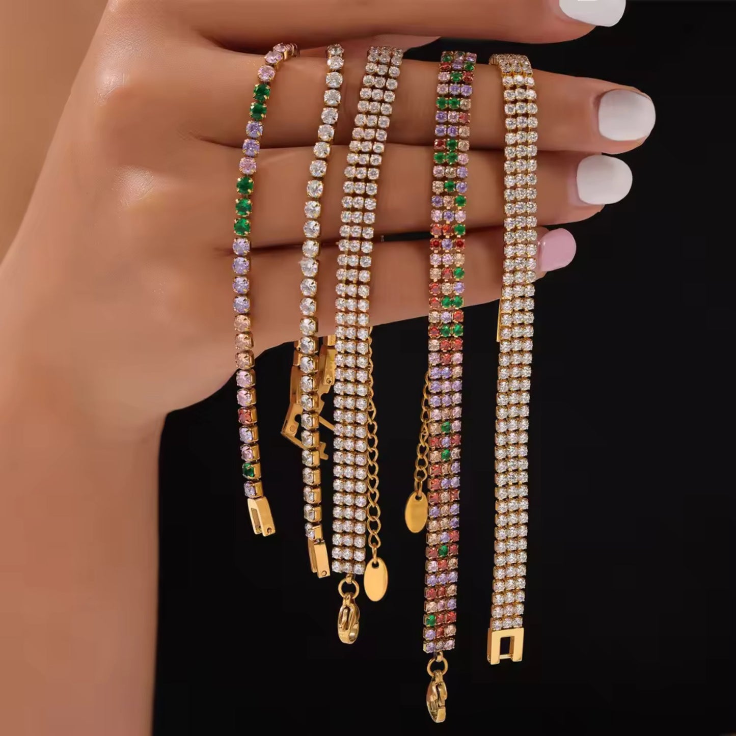Vibrant multi-row zirconia tennis bracelet with green, pink, and purple stones, displayed by a model.