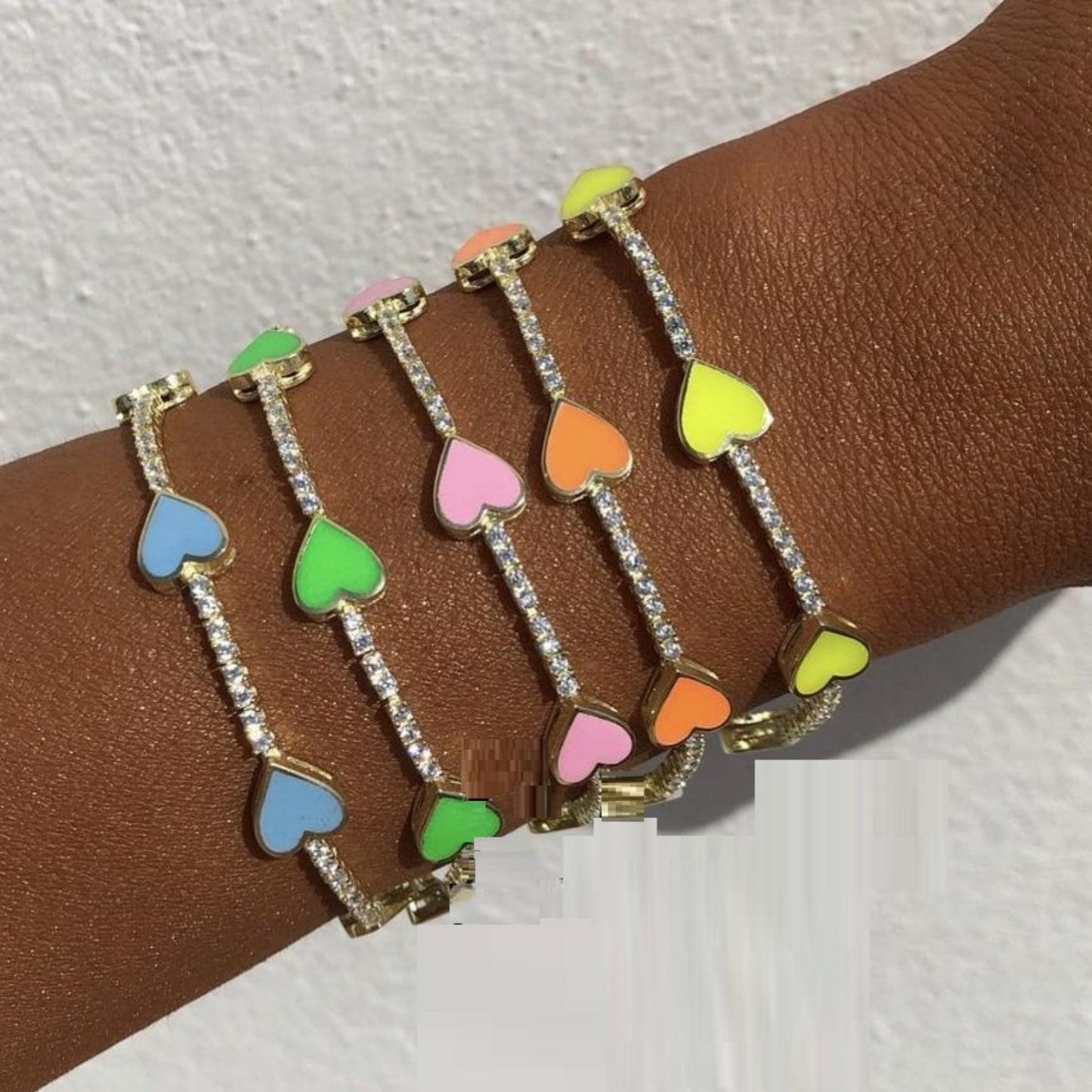 Detailed view of the Enamel Heart Gold Plated Bracelet, showcasing vibrant enamel hearts and sparkling cubic zirconia accents.