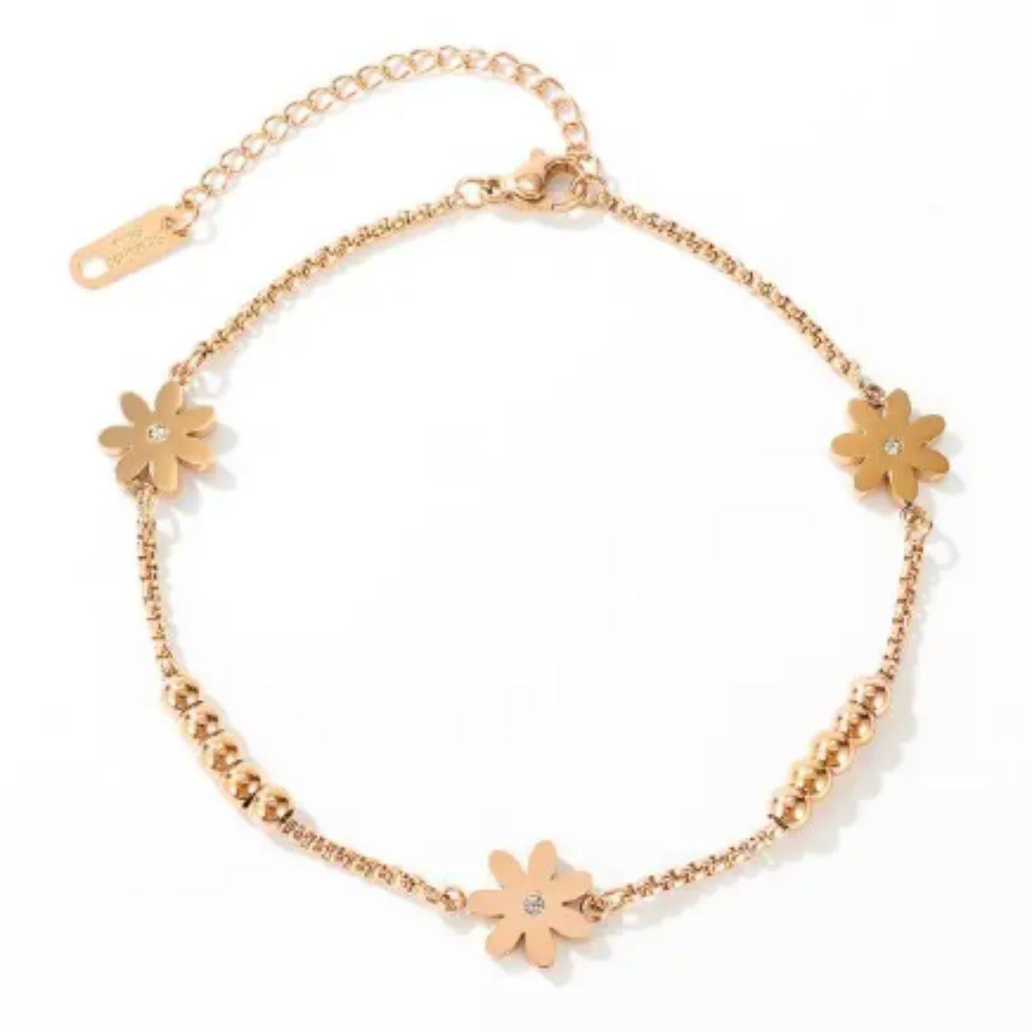 Floral Charm 18K Rose Gold Plated Anklet laid flat on a white background, highlighting its design and adjustable chain.