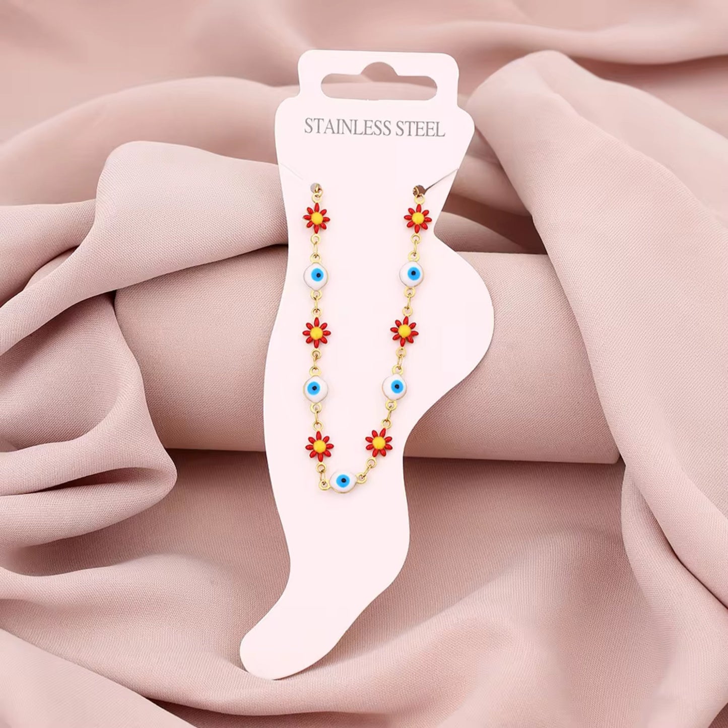 Floral Evil Eye Waterproof Charm Anklet displayed flat, highlighting its vibrant charms and adjustable design.
