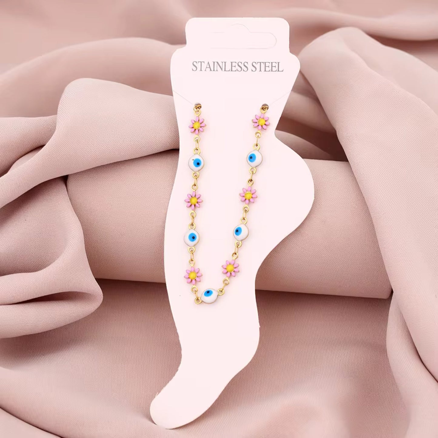 Floral Evil Eye Waterproof Charm Anklet displayed flat, highlighting its vibrant charms and adjustable design.