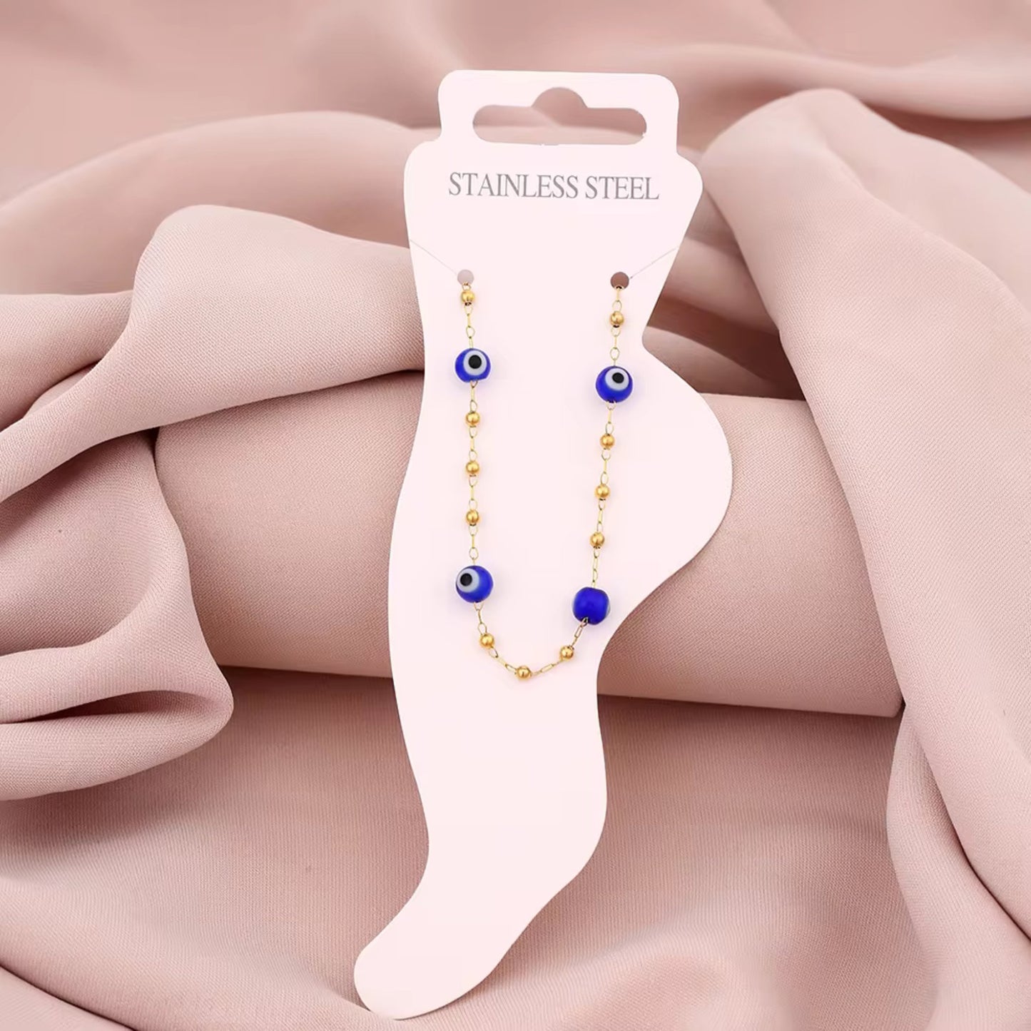 Floral Evil Eye Waterproof Charm Anklet displayed flat, highlighting its vibrant charms and adjustable design.