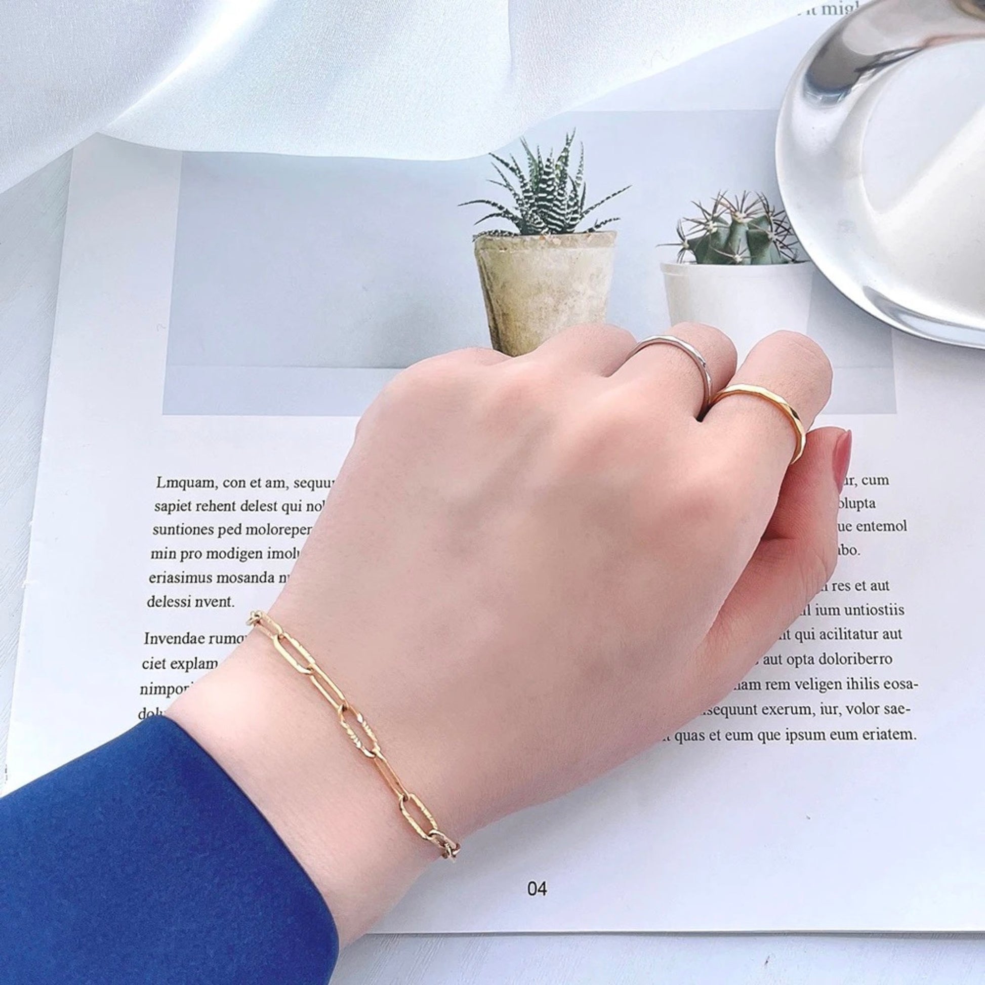 Model wearing the 18K gold plated minimalist link chain bracelet made of durable stainless steel, featuring an adjustable length and a secure lobster clasp for a chic and versatile look