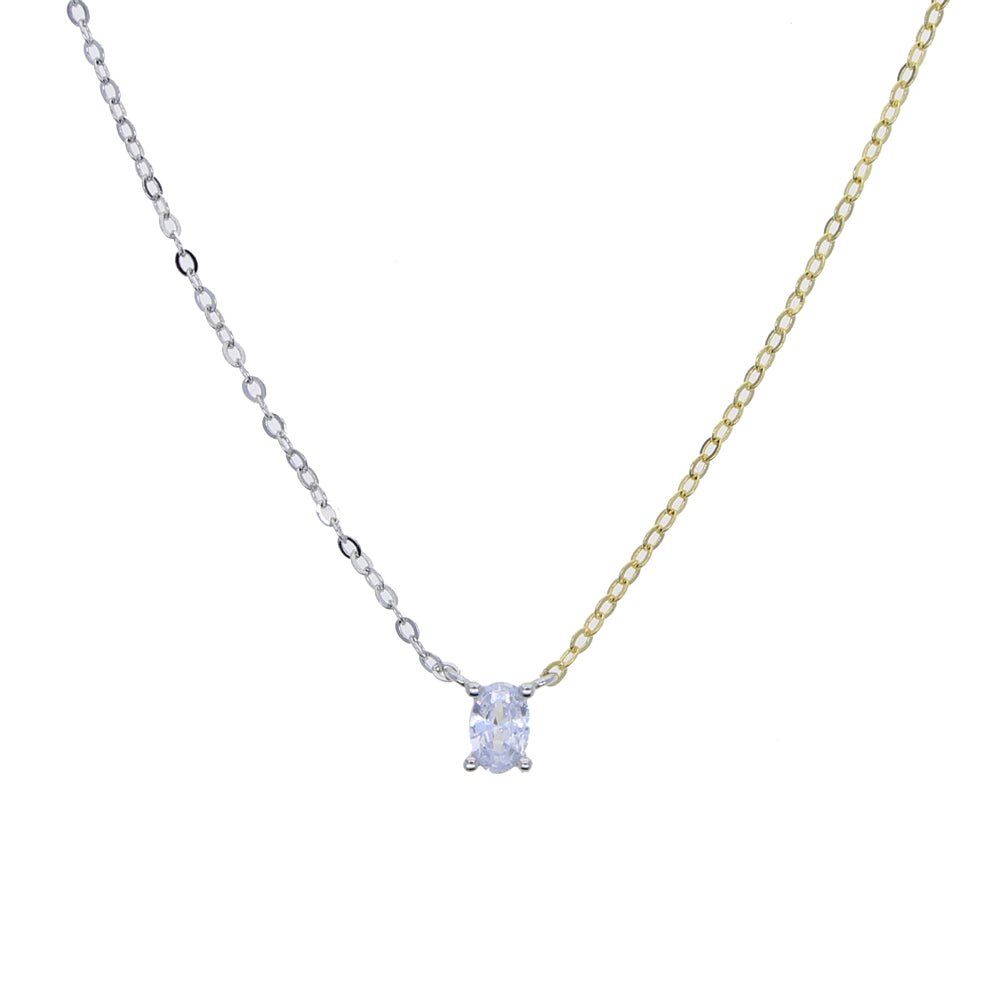 Close-up of the oval-shaped white zirconia pendant on a two-tone chain necklace with gold and platinum plating.