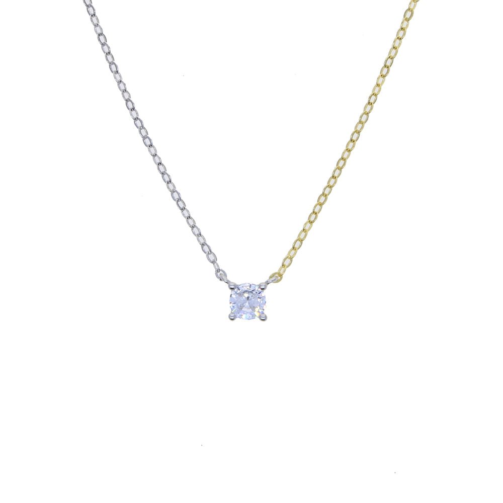 Close-up of the round-shaped white zirconia pendant on a modern two-tone chain necklace.
