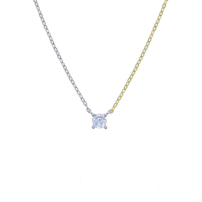 Close-up of the round-shaped white zirconia pendant on a modern two-tone chain necklace.