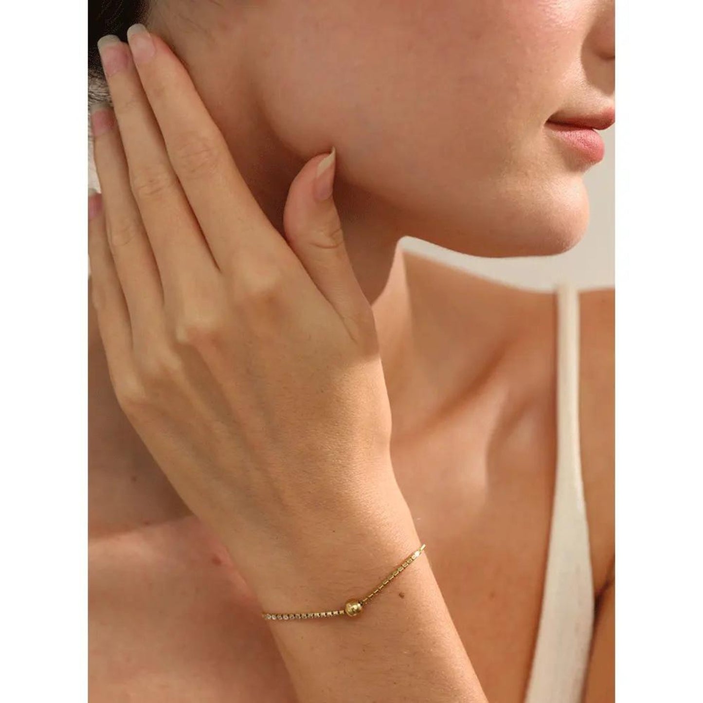 Adjustable Gold-Plated Zircon Charm Bracelet with sparkling zircon stones and a round ball accent, shown on a model's wrist for an elegant everyday look.