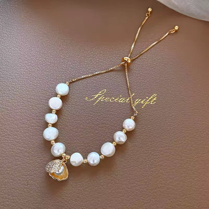 White Pearl Braided Bracelet styled on a wrist, showcasing its adjustable fit and luxurious design.