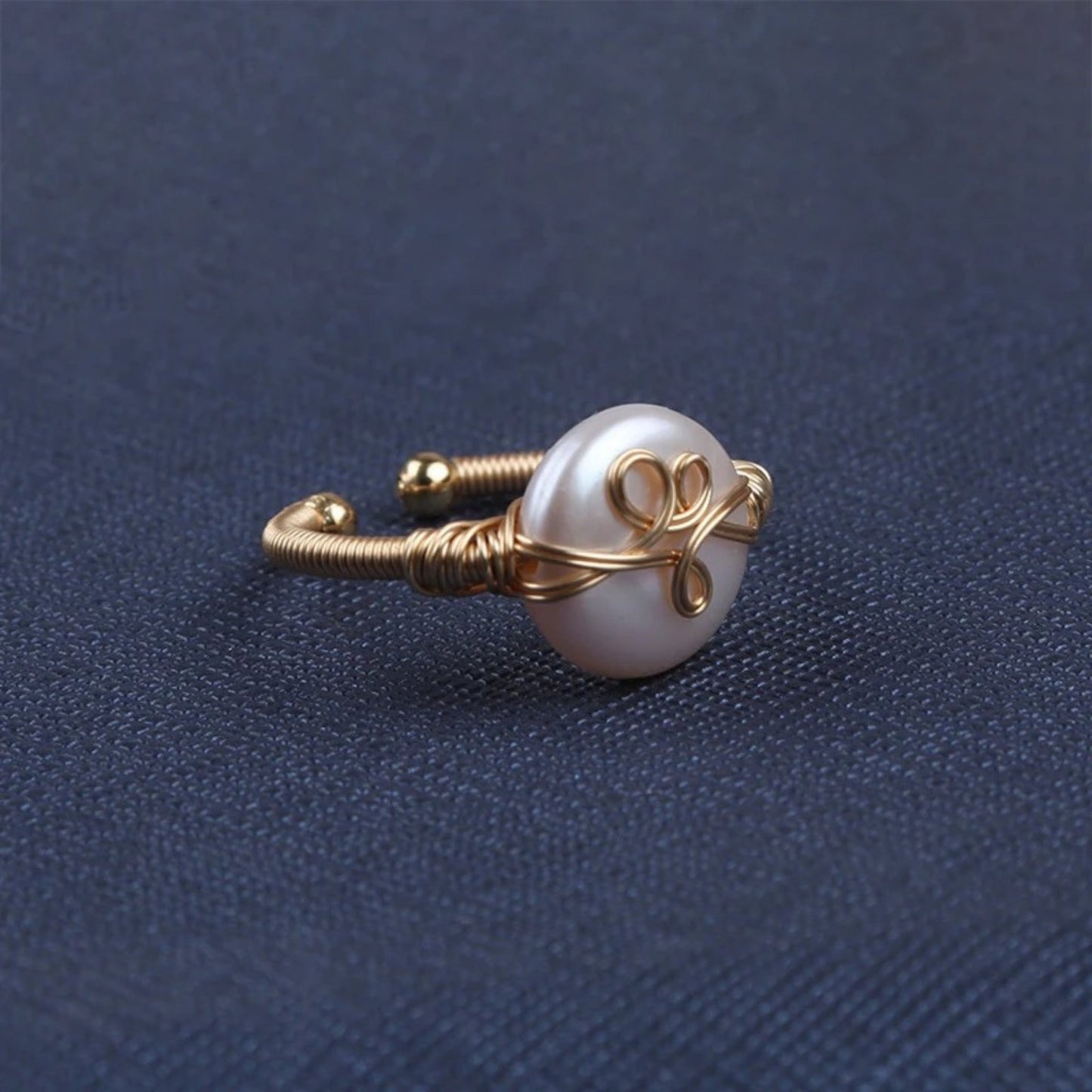 Smooth freshwater pearl ring with a sleek 18K gold-plated band and textured gold accent, offering artisanal elegance.