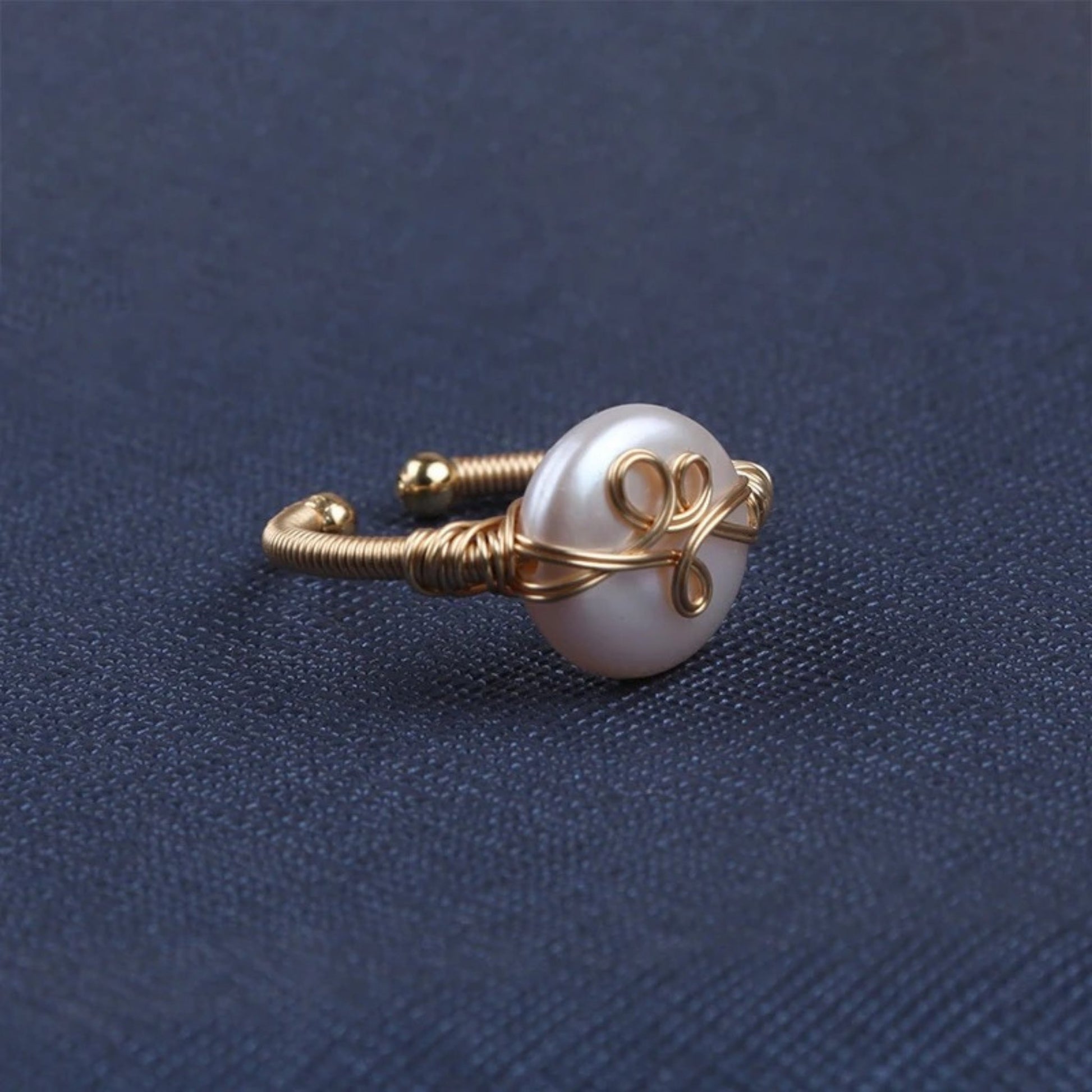 Smooth freshwater pearl ring with a sleek 18K gold-plated band and textured gold accent, offering artisanal elegance.