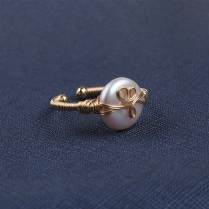 Smooth freshwater pearl ring with a sleek 18K gold-plated band and textured gold accent, offering artisanal elegance.